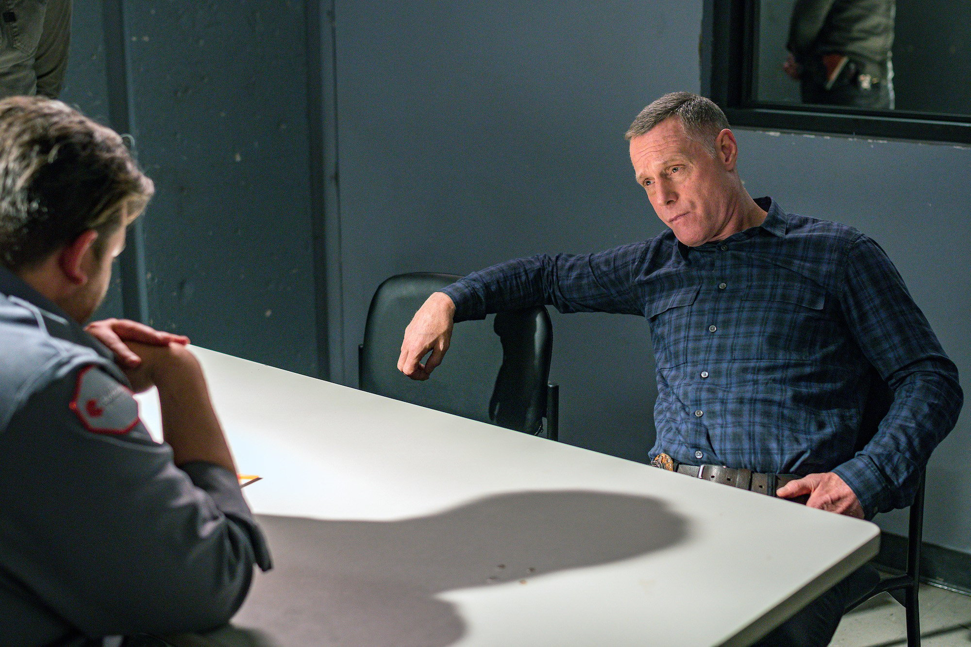 Jason Beghe as Hank Voight sitting in an interrogation room on 'Chicago P.D.'
