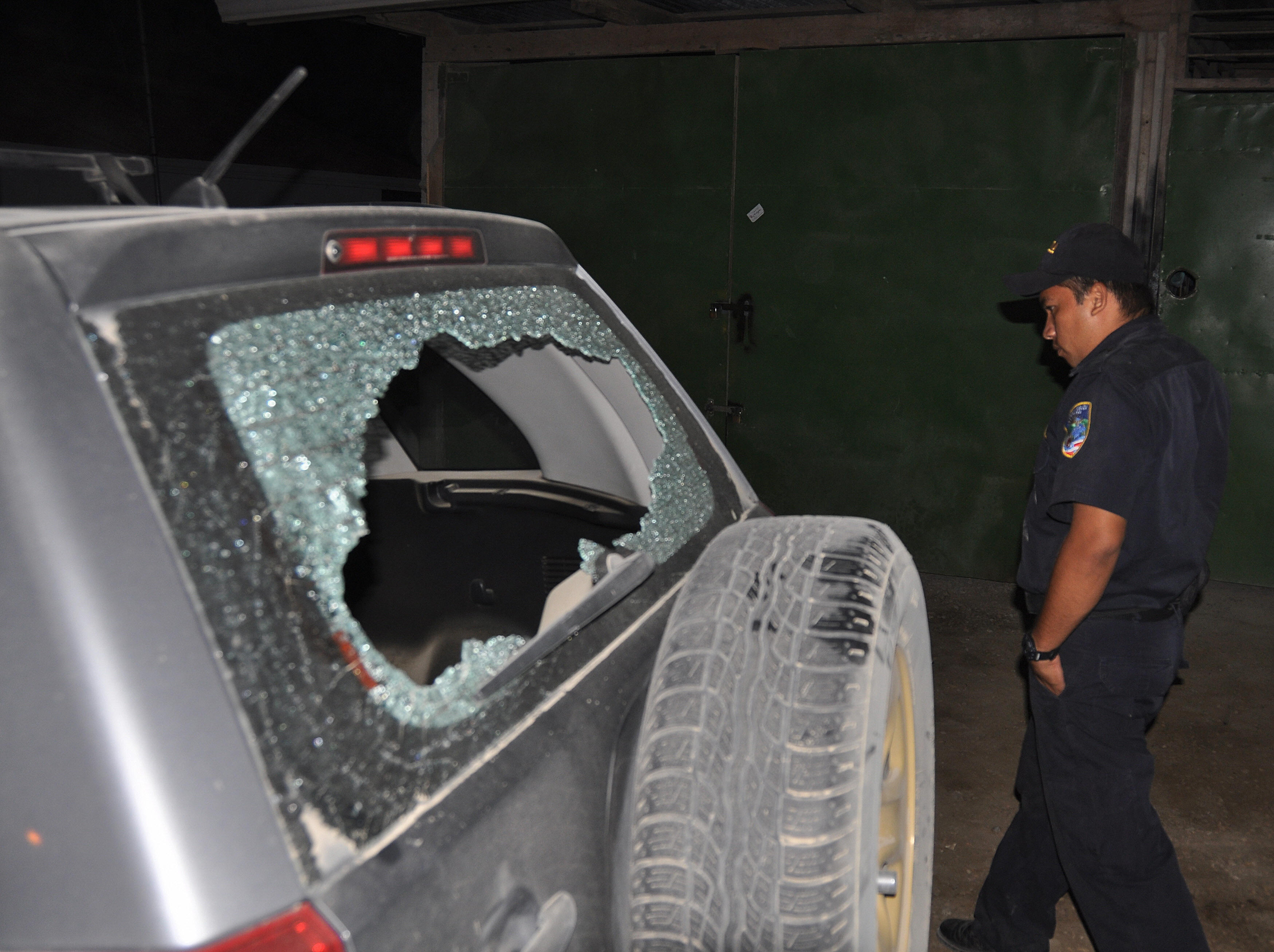 Costa Rican police officer inspects the damages caused by gunfire at Tom and Gisele's wedding