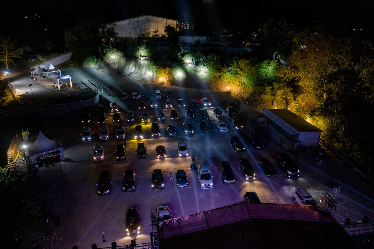 People watch musicians perform from their cars during a drive-in music concert amid the coronavirus pandemic on September 20, 2020 