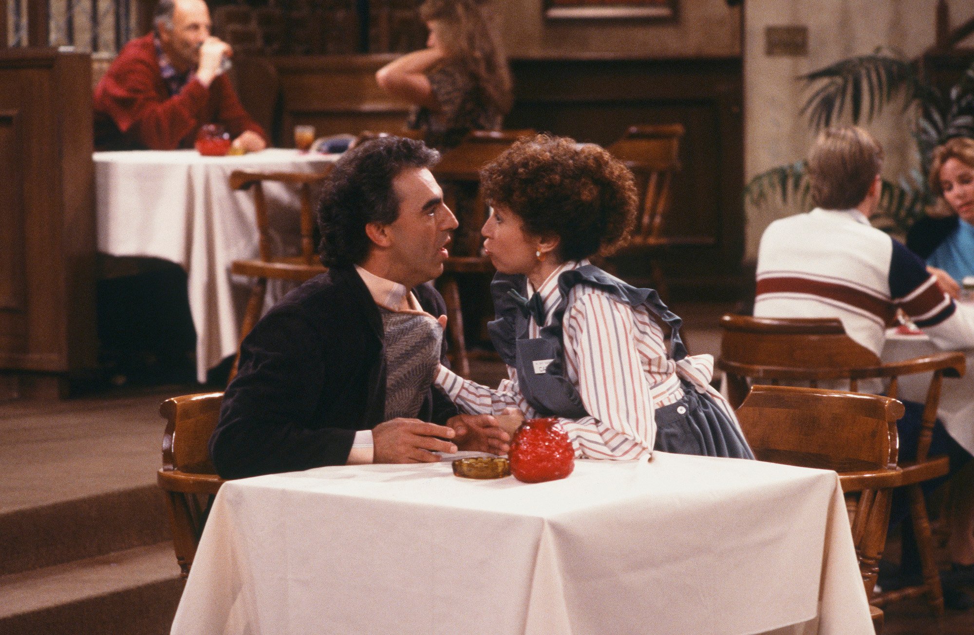 (l-r) Jay Thomas as Eddie LeBec, Rhea Perlman as Carla Tortelli, arguing, with Carla gripping Eddie's shirt