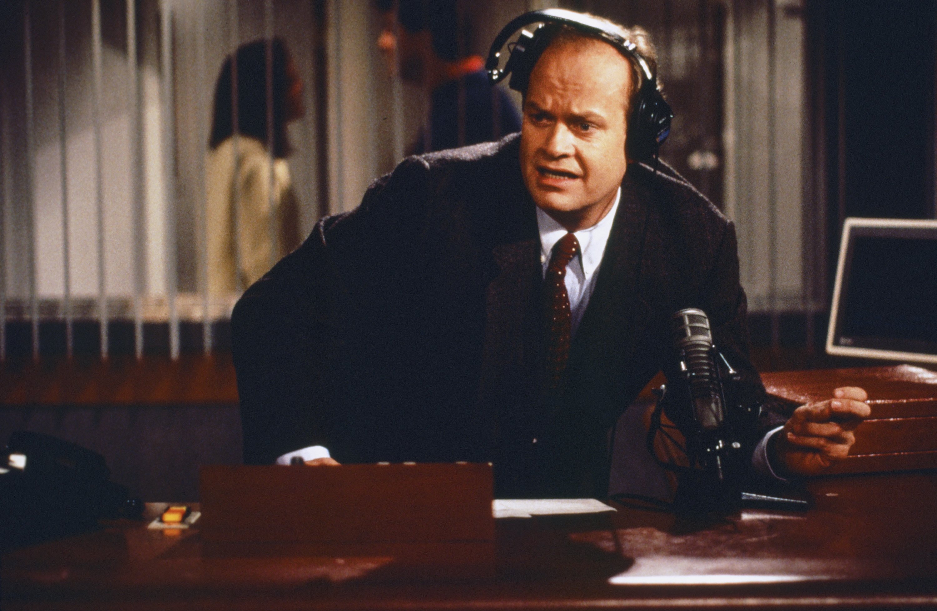 Kelsey Grammer as Doctor Frasier Crane in his radio studio