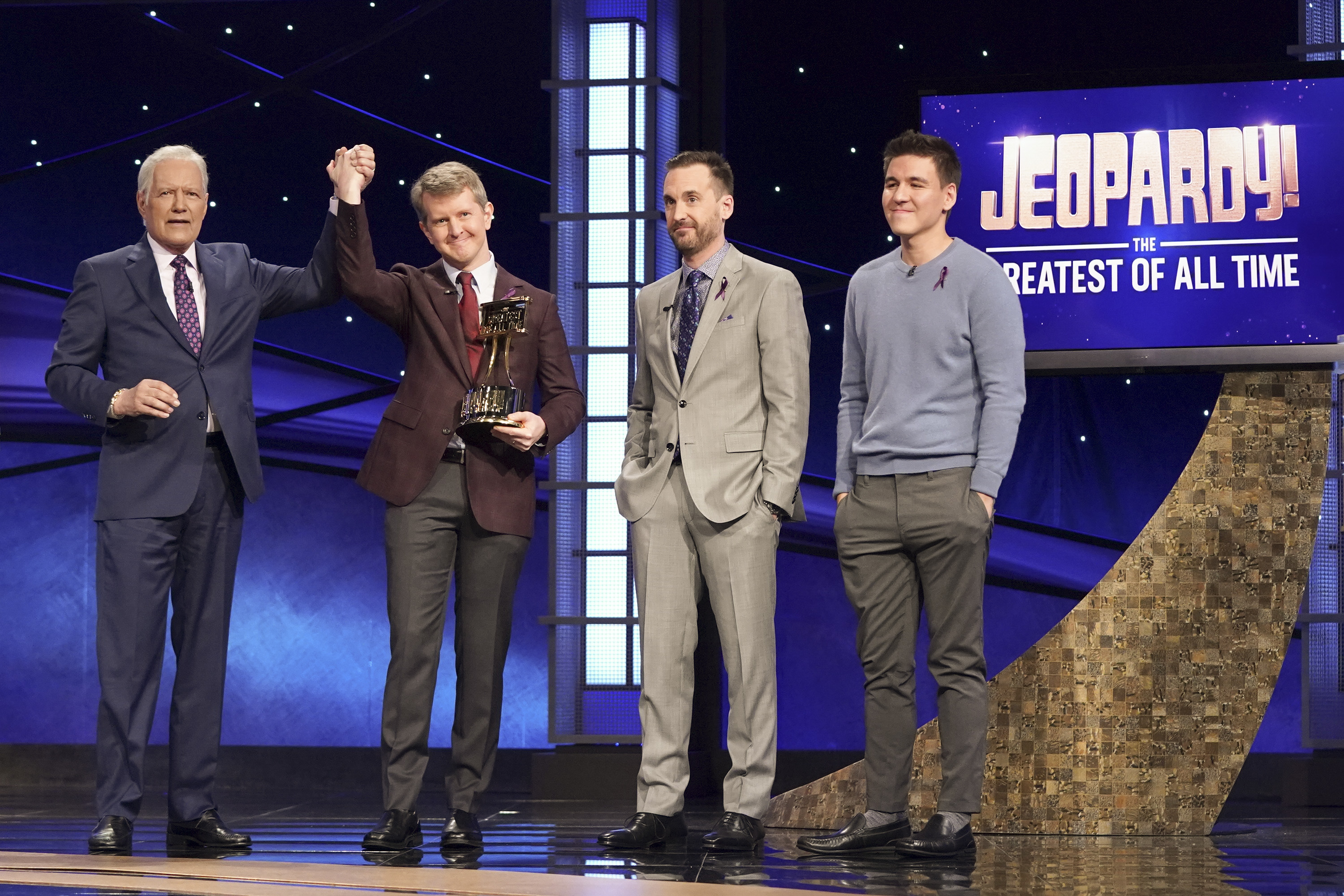 Ken Jennings, Brad Rutter, and James Holzhauer vied for the title of Greatest 'Jeopardy!' Player of All Time, pictured here with (far left) host Alex Trebek in Jan. 2020