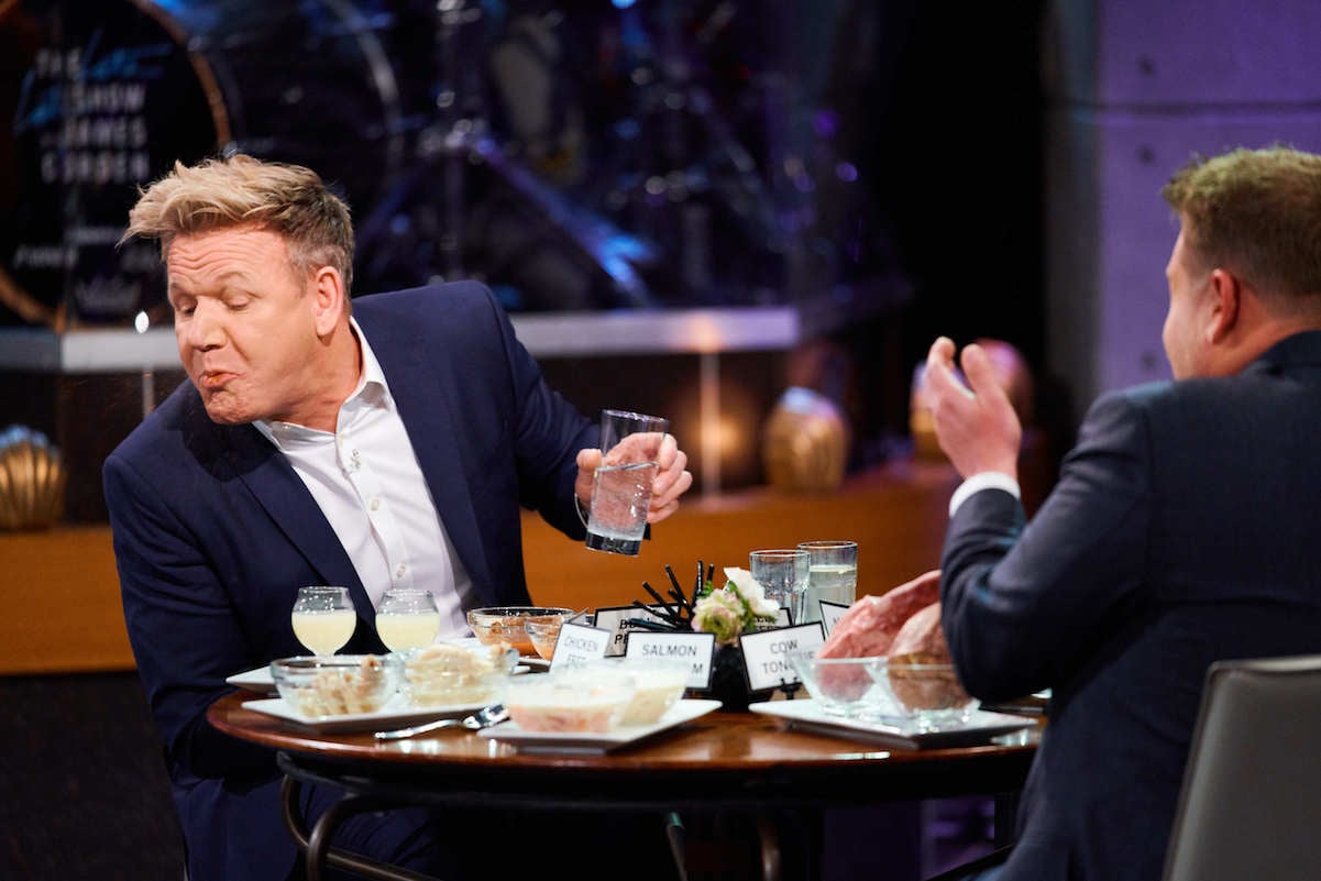 Gordon Ramsay spits food out in front of James Corden. 