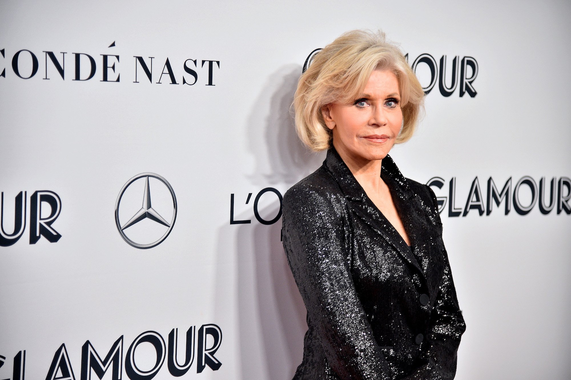 Jane Fonda smiling slightly in front of a white background