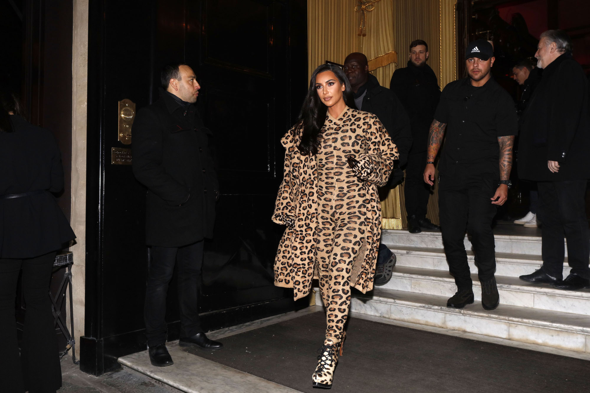 Kim Kardashian West walking out of a building surrounded by security