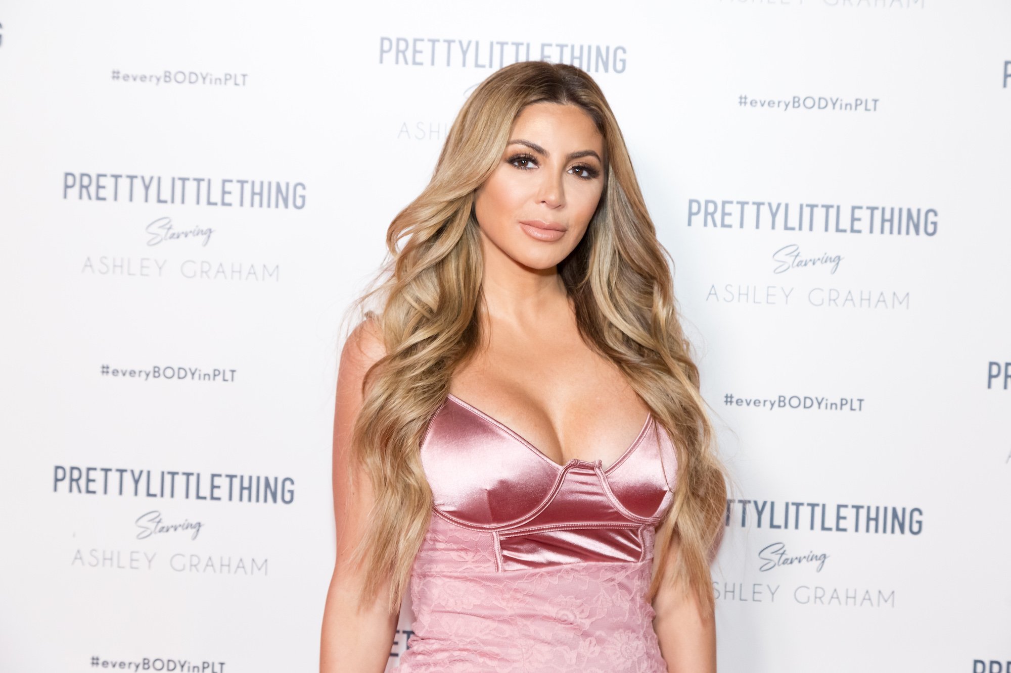 Larsa Pippen smiling slightly in front of a white background