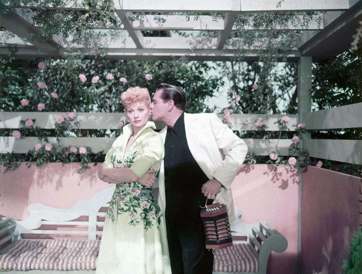 Lucille Ball getting kissed on the cheek by then-husband, Desi Arnaz 