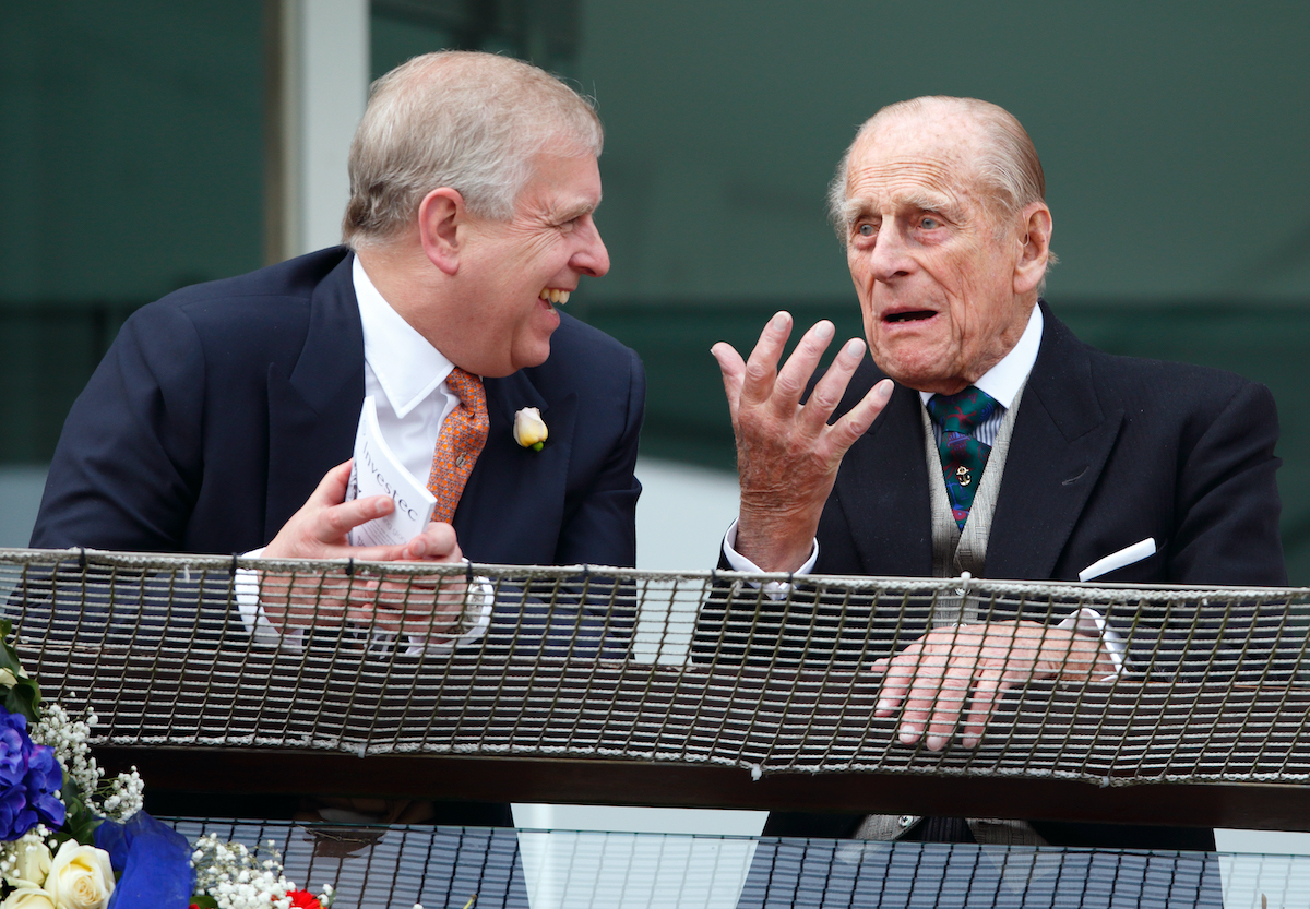 Prince Philip, Duke of Edinburgh and Prince Andrew, Duke of York watch the racing from the balcony of the Royal Box as they attend Derby Day during the Investec Derby Festival at Epsom Racecourse on June 4, 2016 in Epsom, England