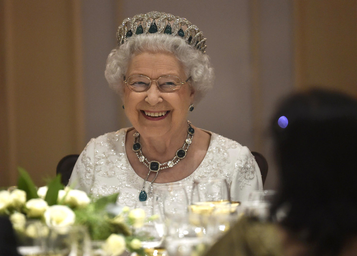 Queen Elizabeth II attends a dinner party.