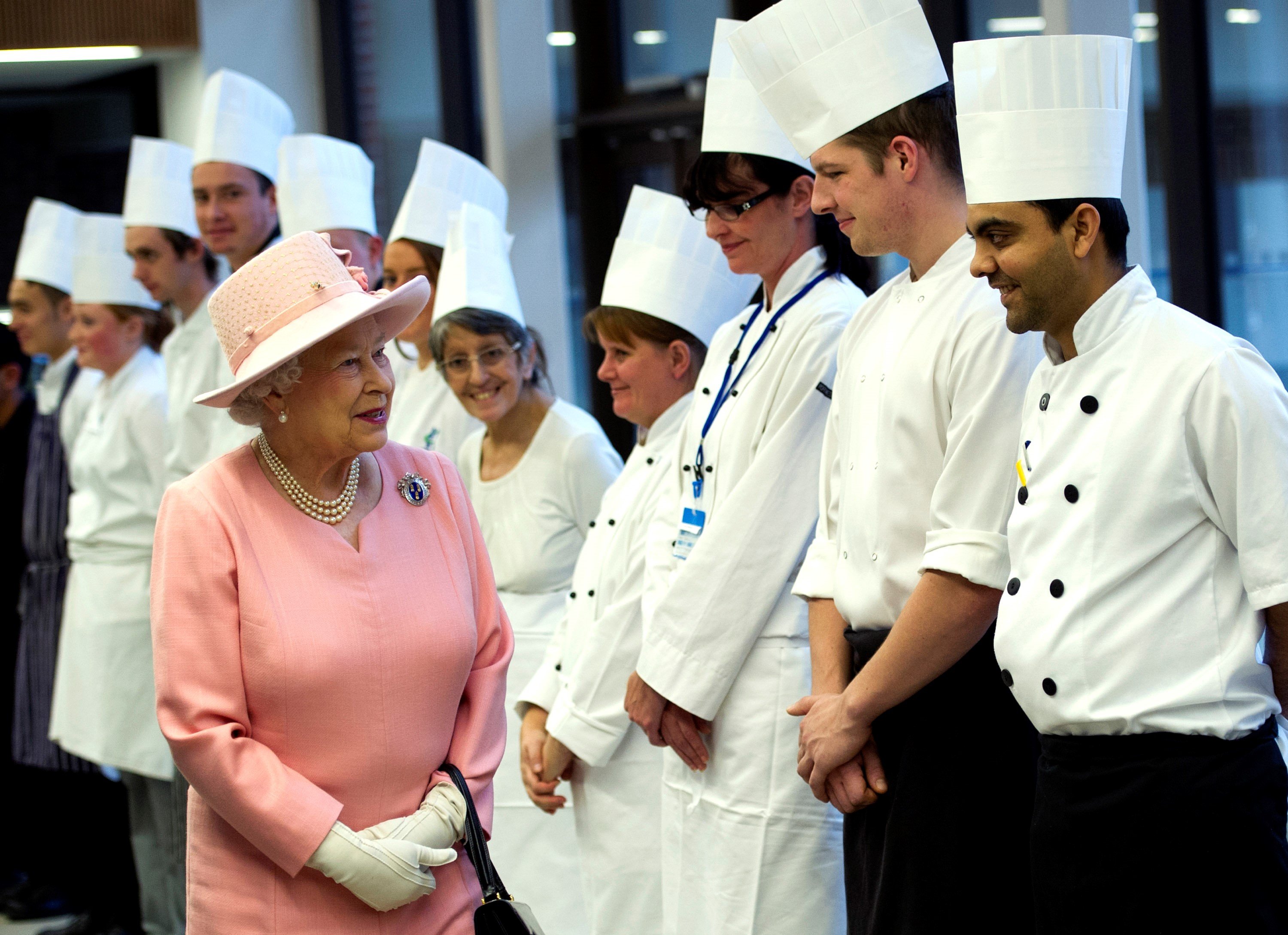 Queen Elizabeth II, Freeman of The Drapers' Company thanks the chefs for her school dinner as she officially opened The Drapers' Academy