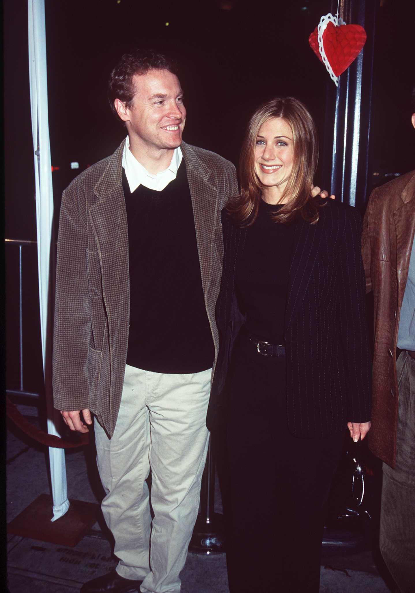 Tate Donovan and Jennifer Aniston arrive at the premiere of 'Fools Rush In'