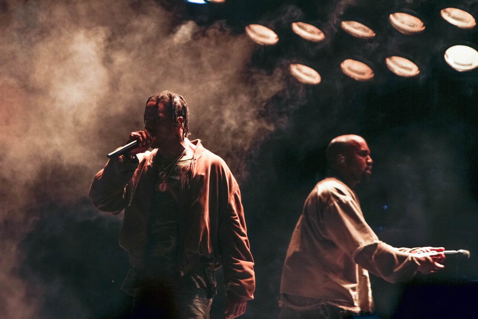 Travis Scott and Kanye West performing on stage