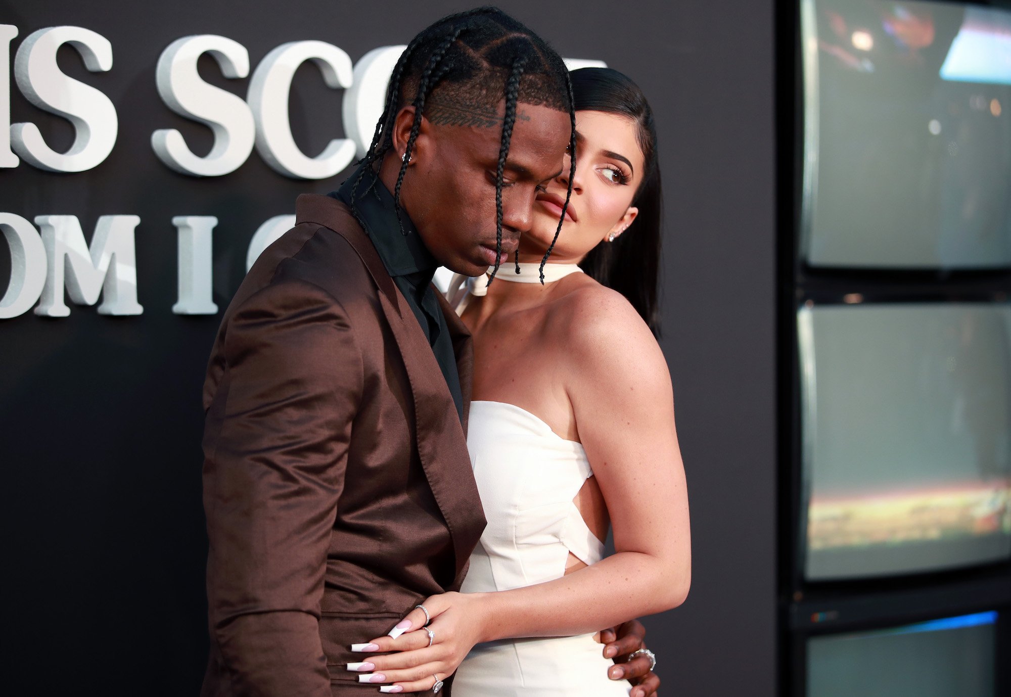 (L-R) Travis Scott and Kylie Jenner, slightly embracing