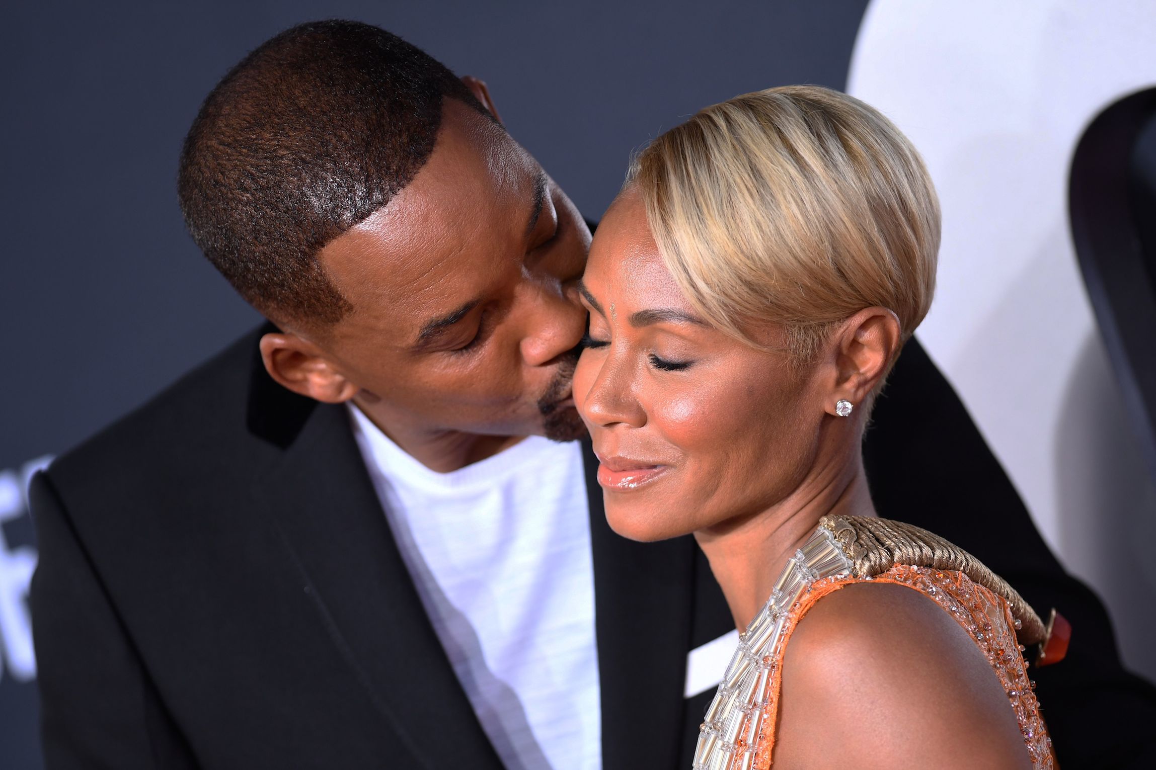 Will Smith (L) kisses Jada Pinkett-Smith as they arrive for the premiere of 'Gemini Man' 