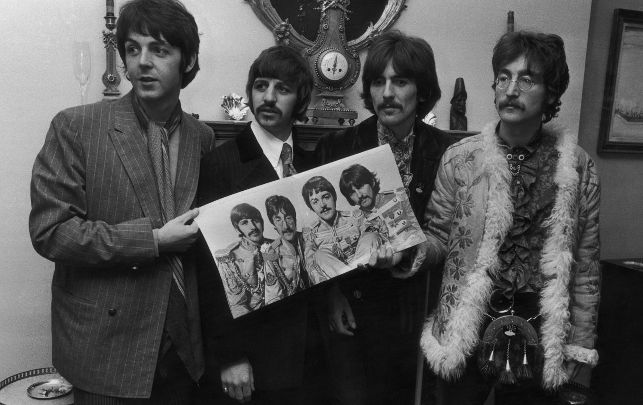 Beatles posing with 'Sgt. Pepper' album