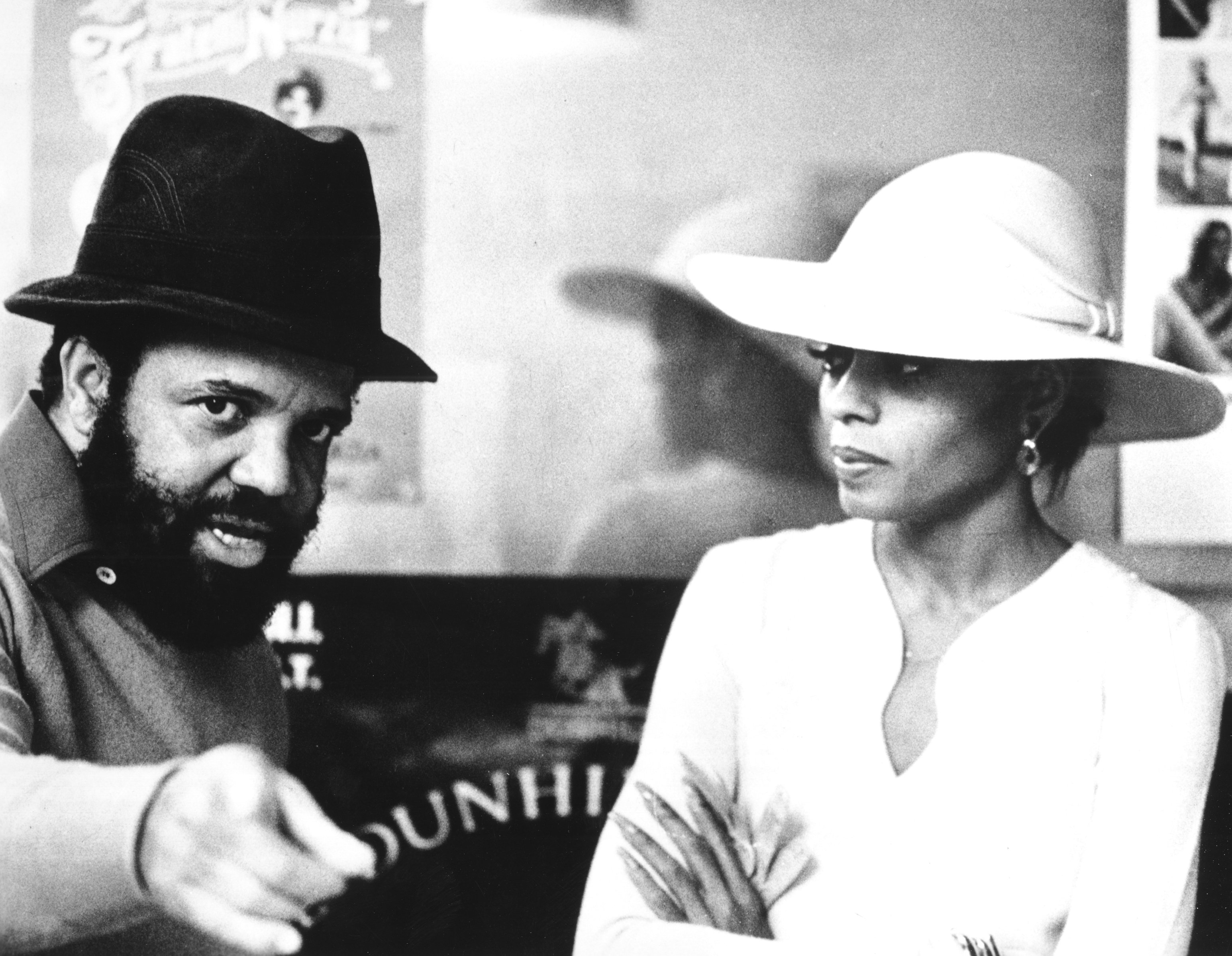 Berry Gordy and Dian Ross wearing hats