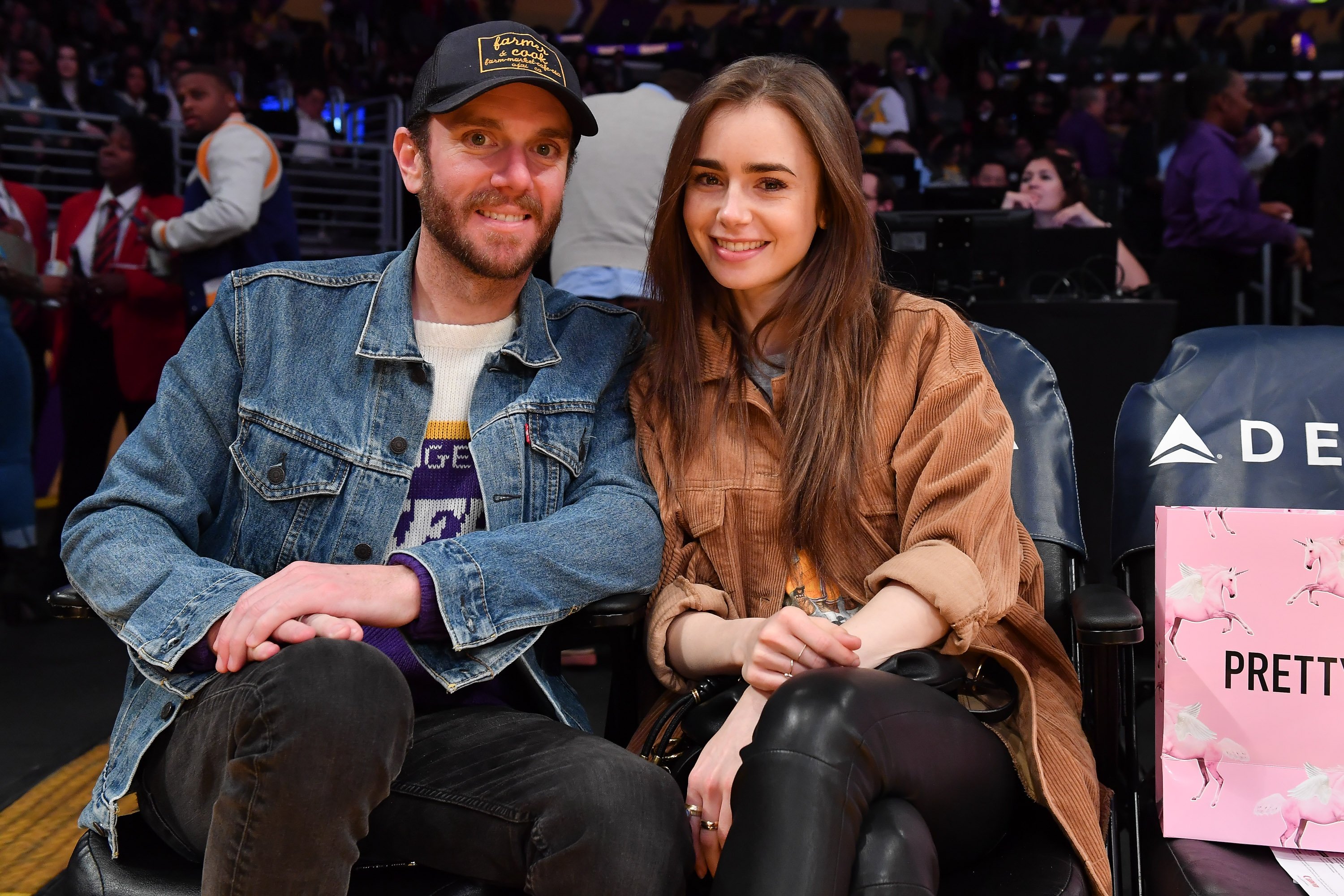 Lily Collins and Charlie McDowell attend a basketball game between the Los Angeles Lakers and the Cleveland Cavaliers on January 13, 2020 