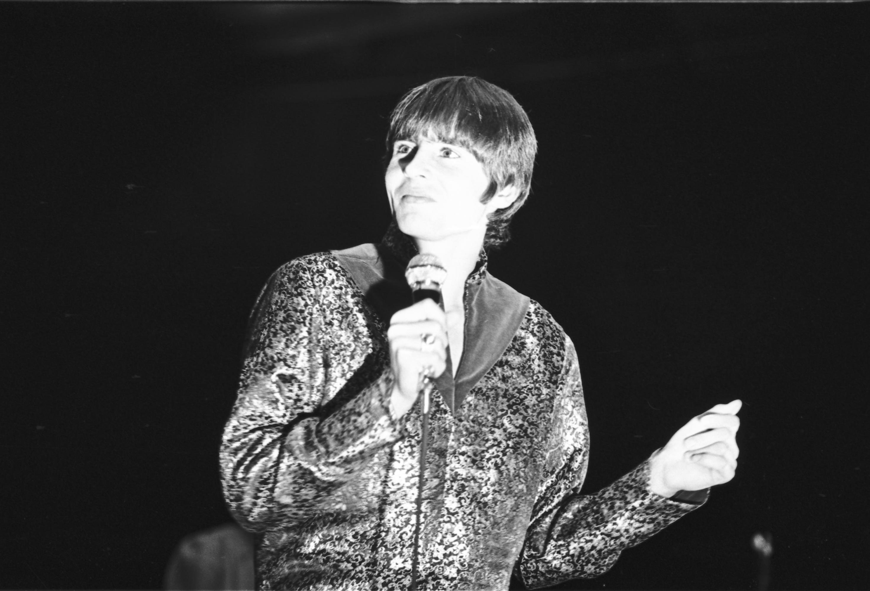 Davy Jones with a microphone