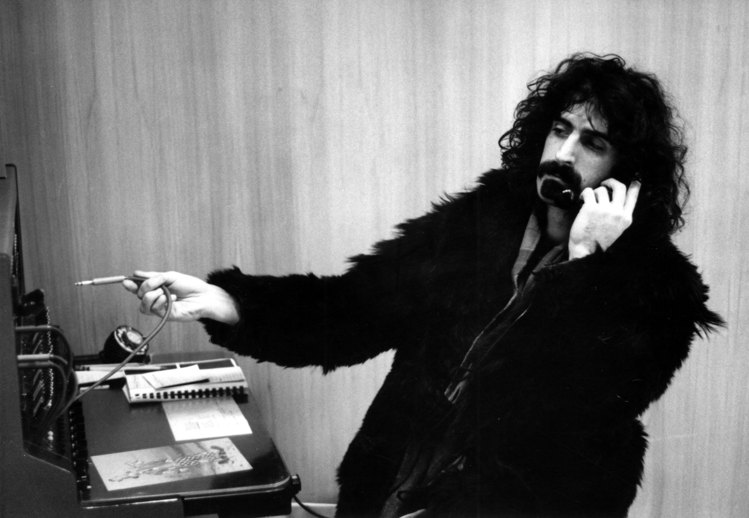 Frank Zappa holding a wire