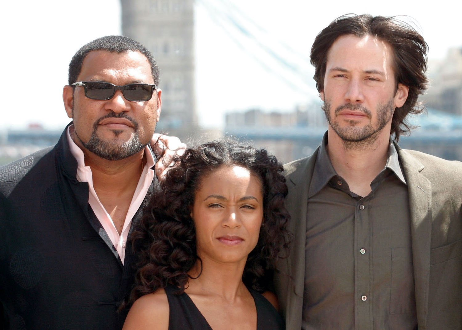 Laurence Fishburne, Jada Pinkett Smith, and Keanu Reeves pose for photographers during a photocall at Old Billingsgate Market in London ahead of the UK premiere of Matrix Reloaded
