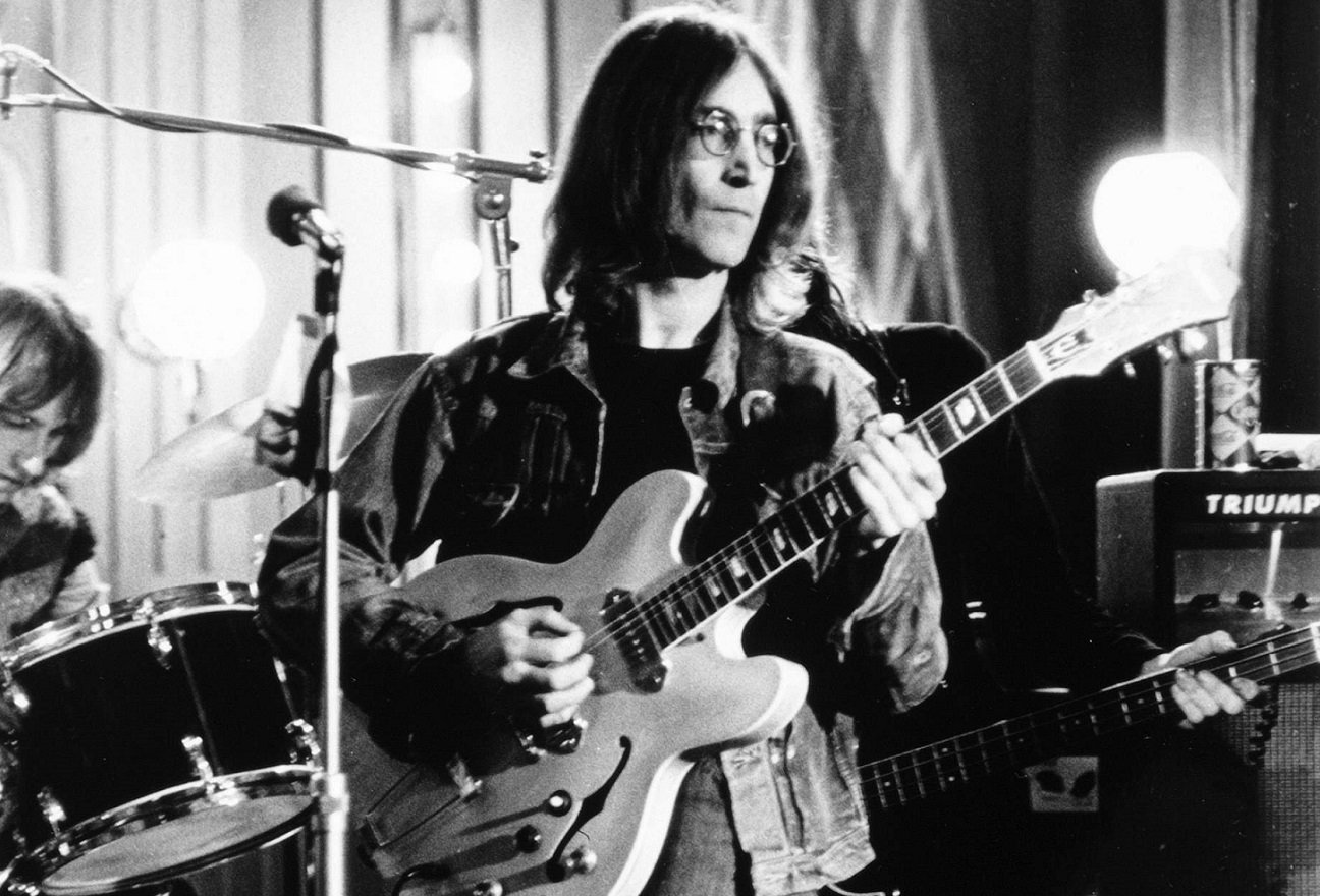 John Lennon playing guitar in 1968