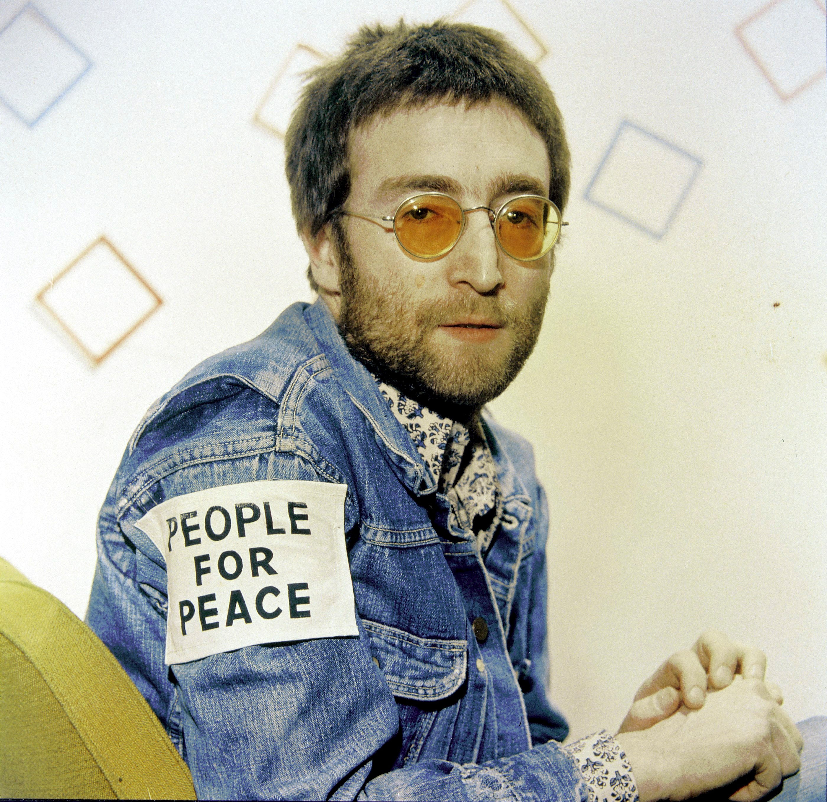 John Lennon wearing a patch reading "People for Peace"