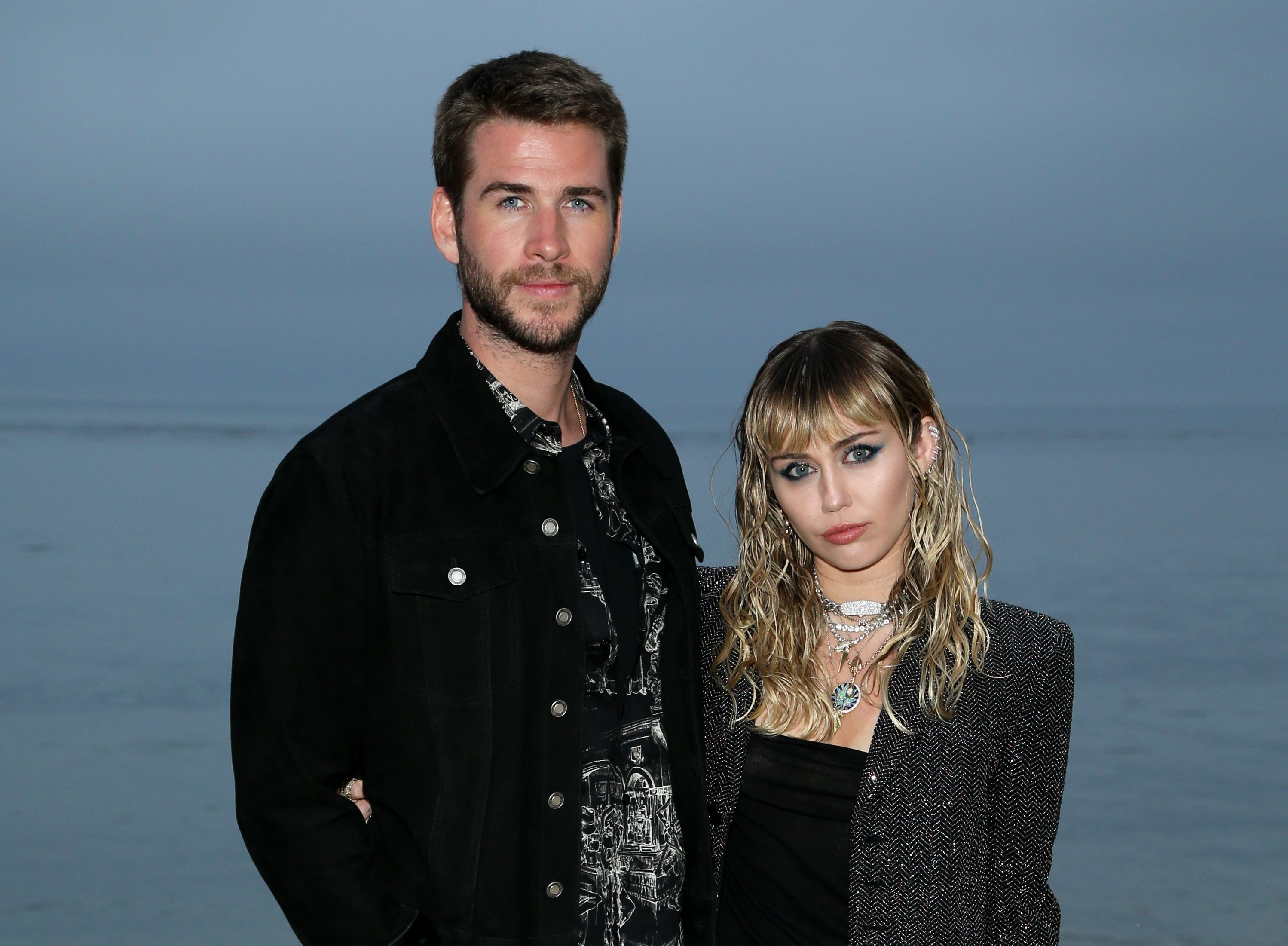 (L-R) Liam Hemsworth and Miley Cyrus attend the Saint Laurent Mens Spring Summer 20 Show on June 6, 2019 in Malibu, California.