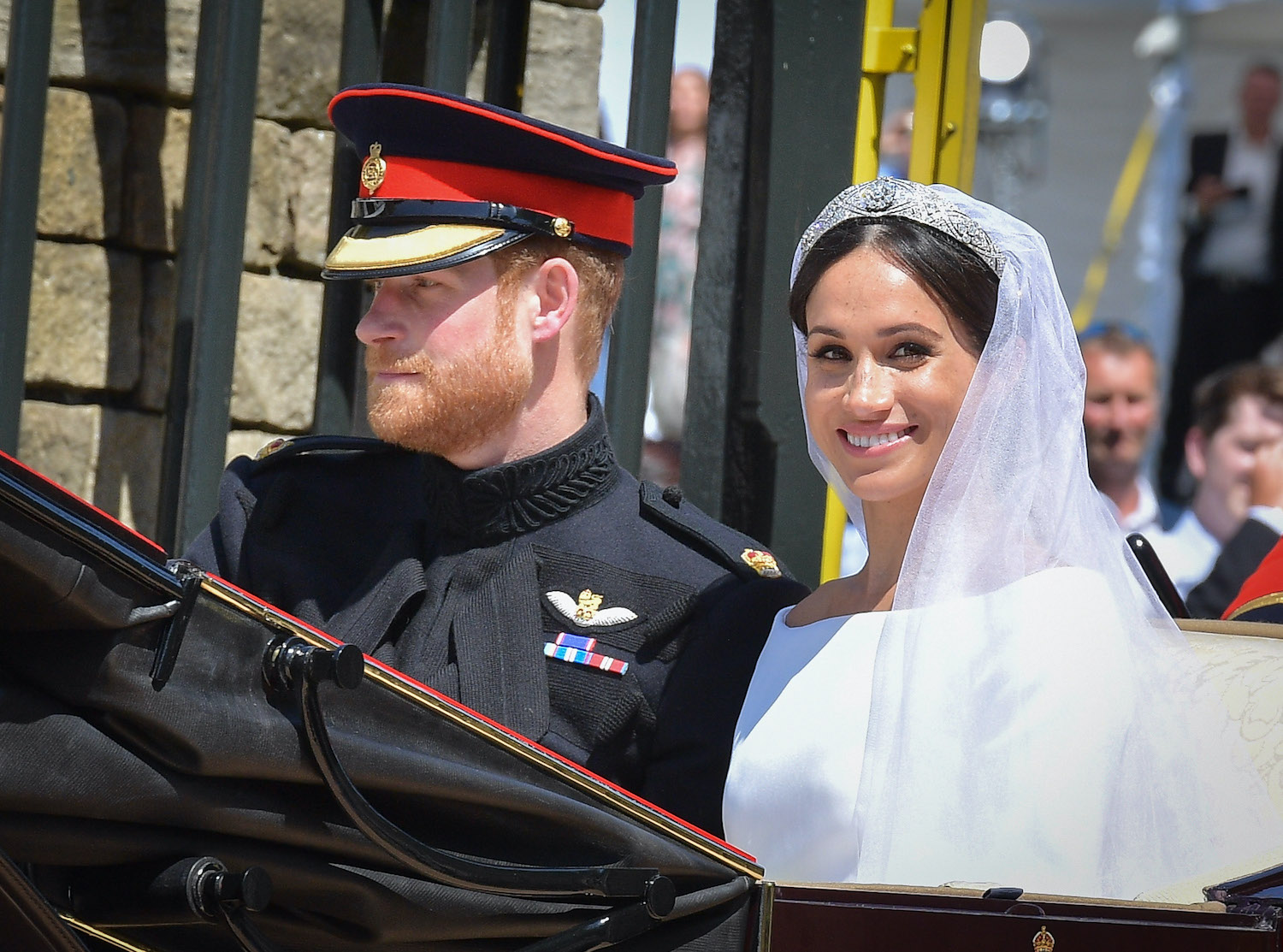 Prince Harry and Meghan Markle leave Windsor Castle in the Ascot Landau carriage during a procession after getting married
