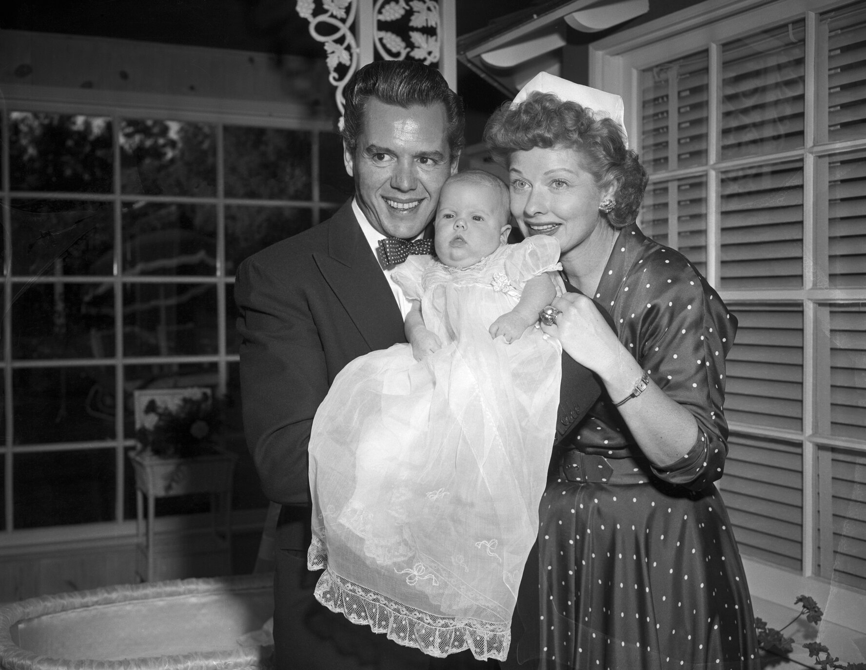 Desi Arnaz and Lucillle Ball pose with their new daughter for the baby's first picture