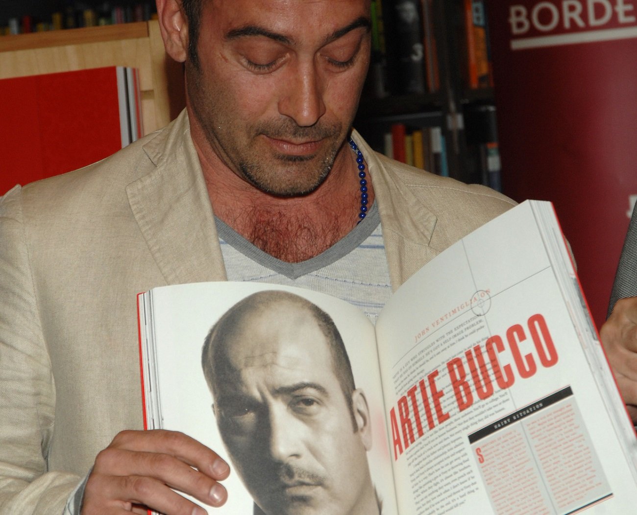 'Sopranos' star John Ventimiglia posing with a book featuring his character