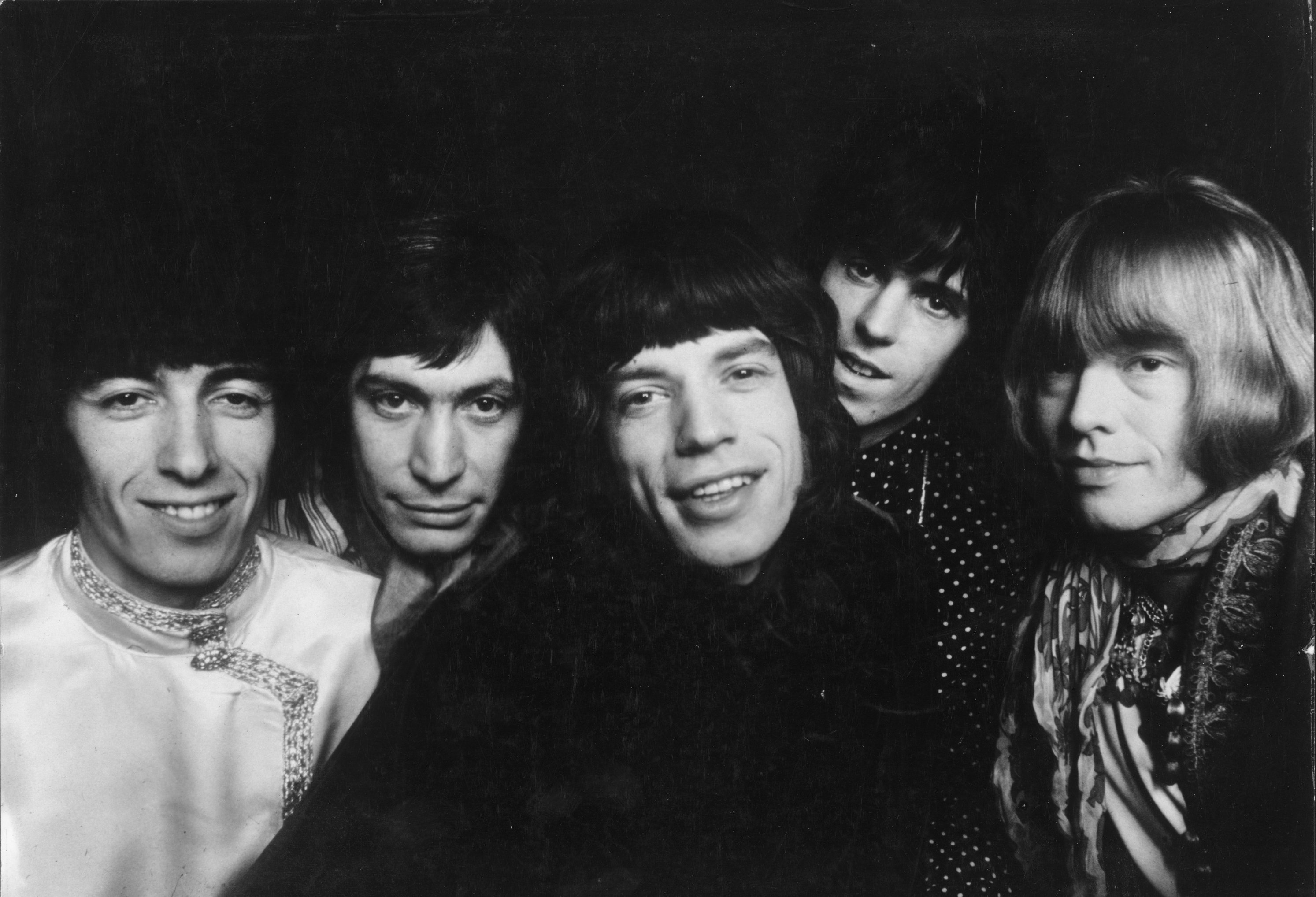The Rolling Stones standing in a row and looking at the camera