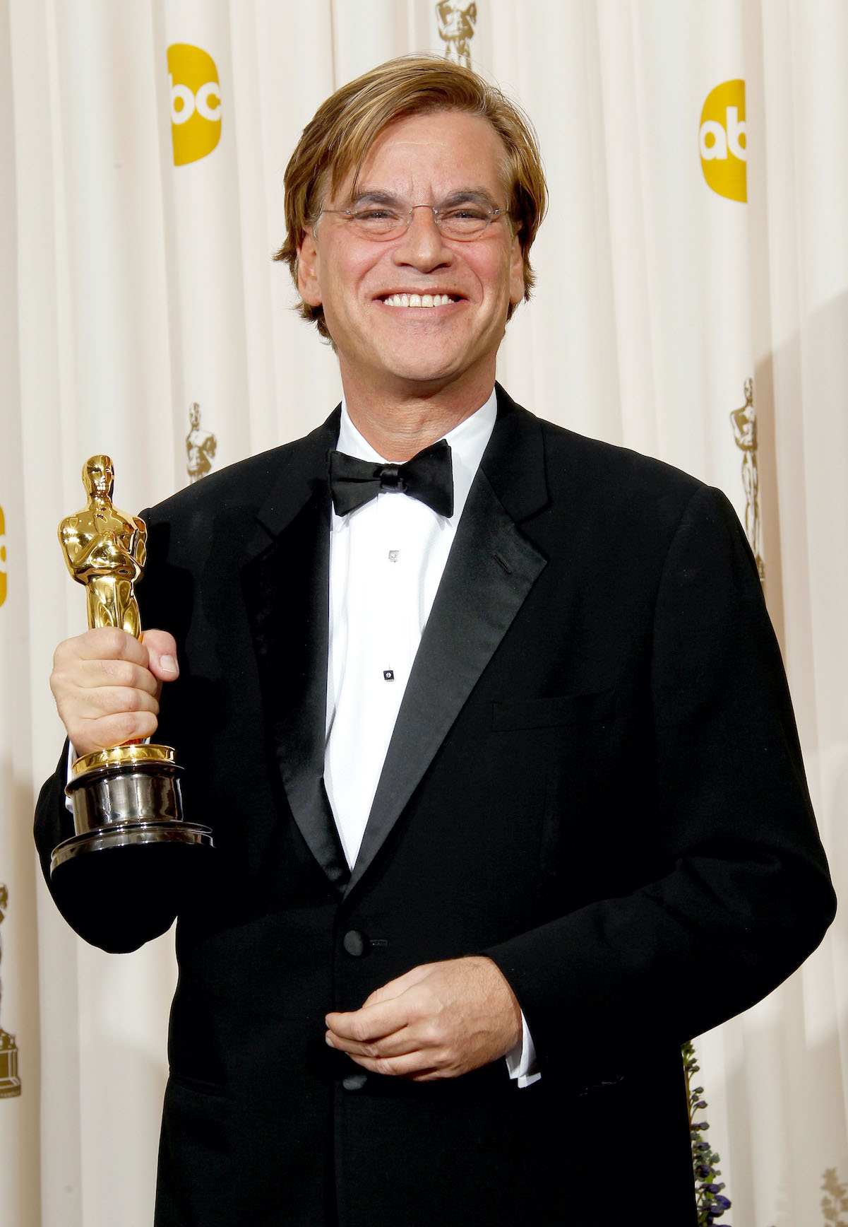 Aaron Sorkin poses with his Oscar statue winning Best Adapted Screenplay for 'The Social Network' in 2011