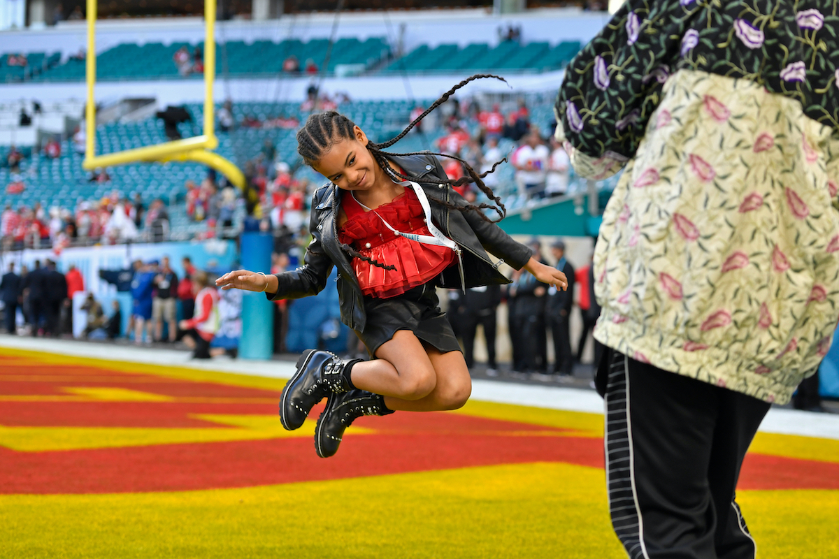 Jay-Z photographs his daughter Blue Ivy Carter as she jumps in the end zone before the start of Super Bowl LIV at Hard Rock Stadium in Miami Gardens, FL on Sunday, Feb. 2, 2020 | Jose Carlos Fajardo/MediaNews Group/The Mercury News via Getty Images
