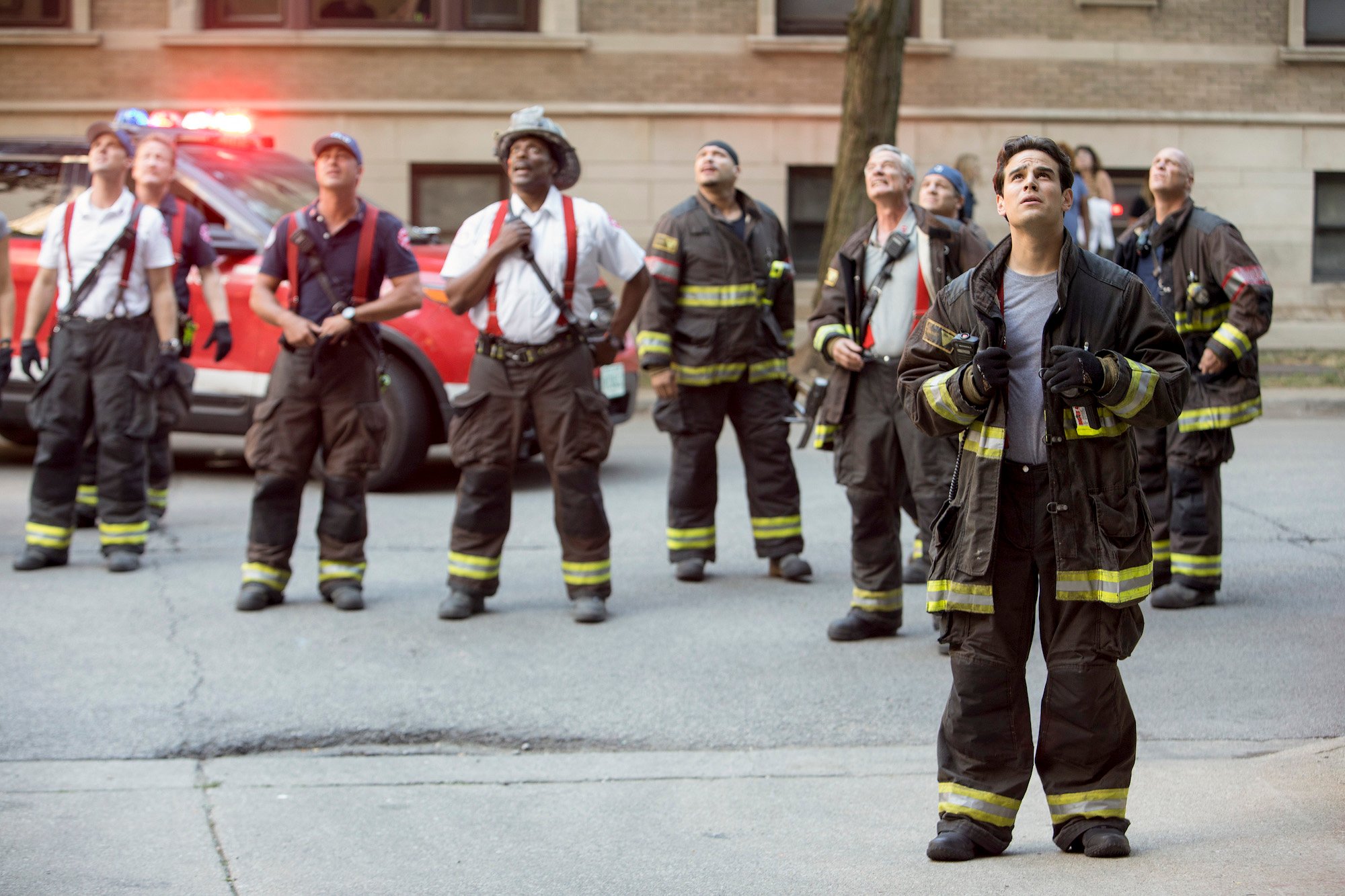 (L-R) Jesse Spencer as Matthew Casey, Christian Stolte as Randy "Mouch" McHolland, Taylor Kinney as Lt Kelly Severide, Eamonn Walker as Battalion Chief Wallace Boden, Joe Minoso as Joe Cruz, Alberto Rosende as Blake Gallo looking up, standing in the street