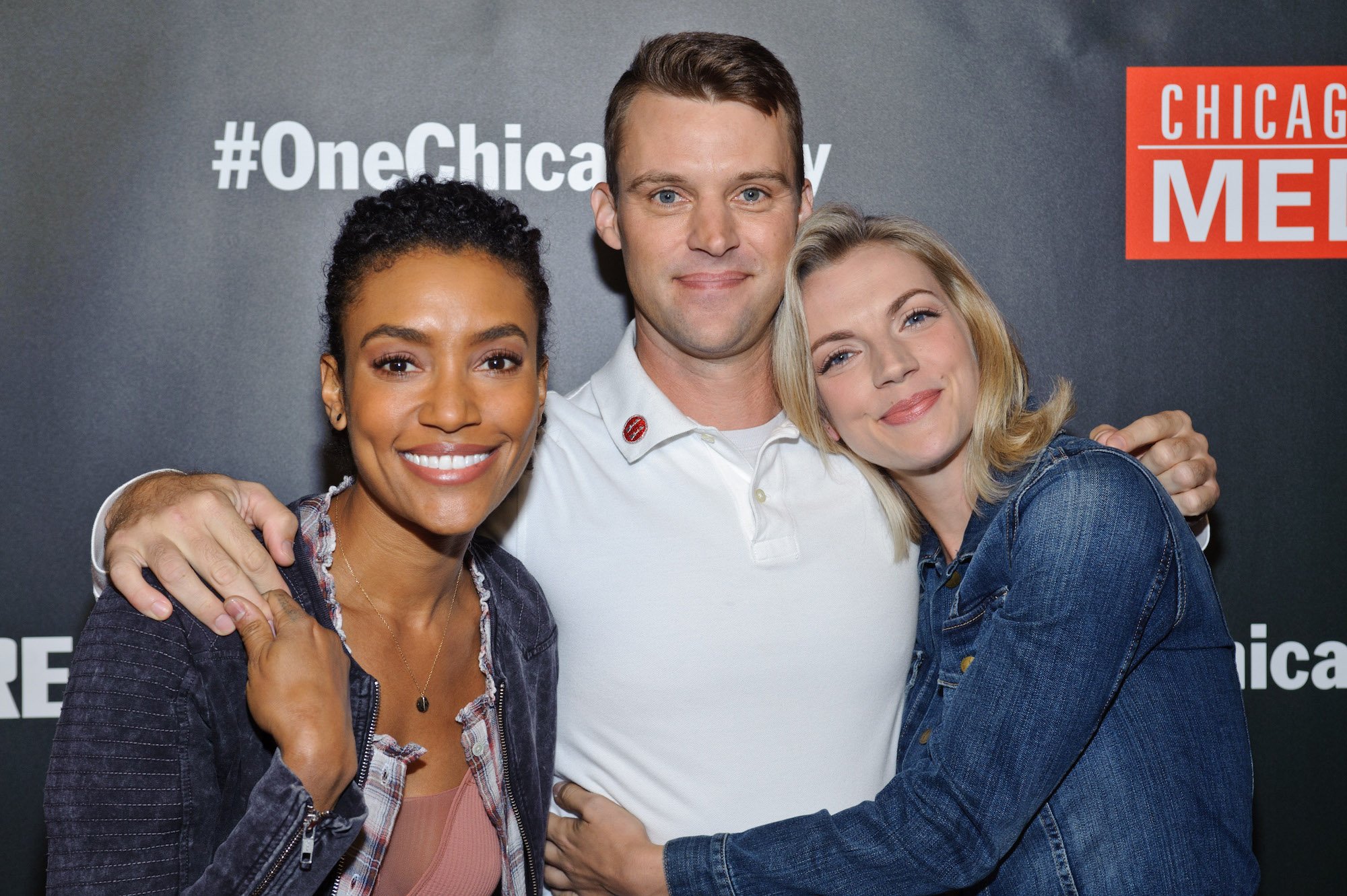 (L-R) Annie Ilonzeh, Jesse Spencer, and Kara Kilmer smiling in front of a black background