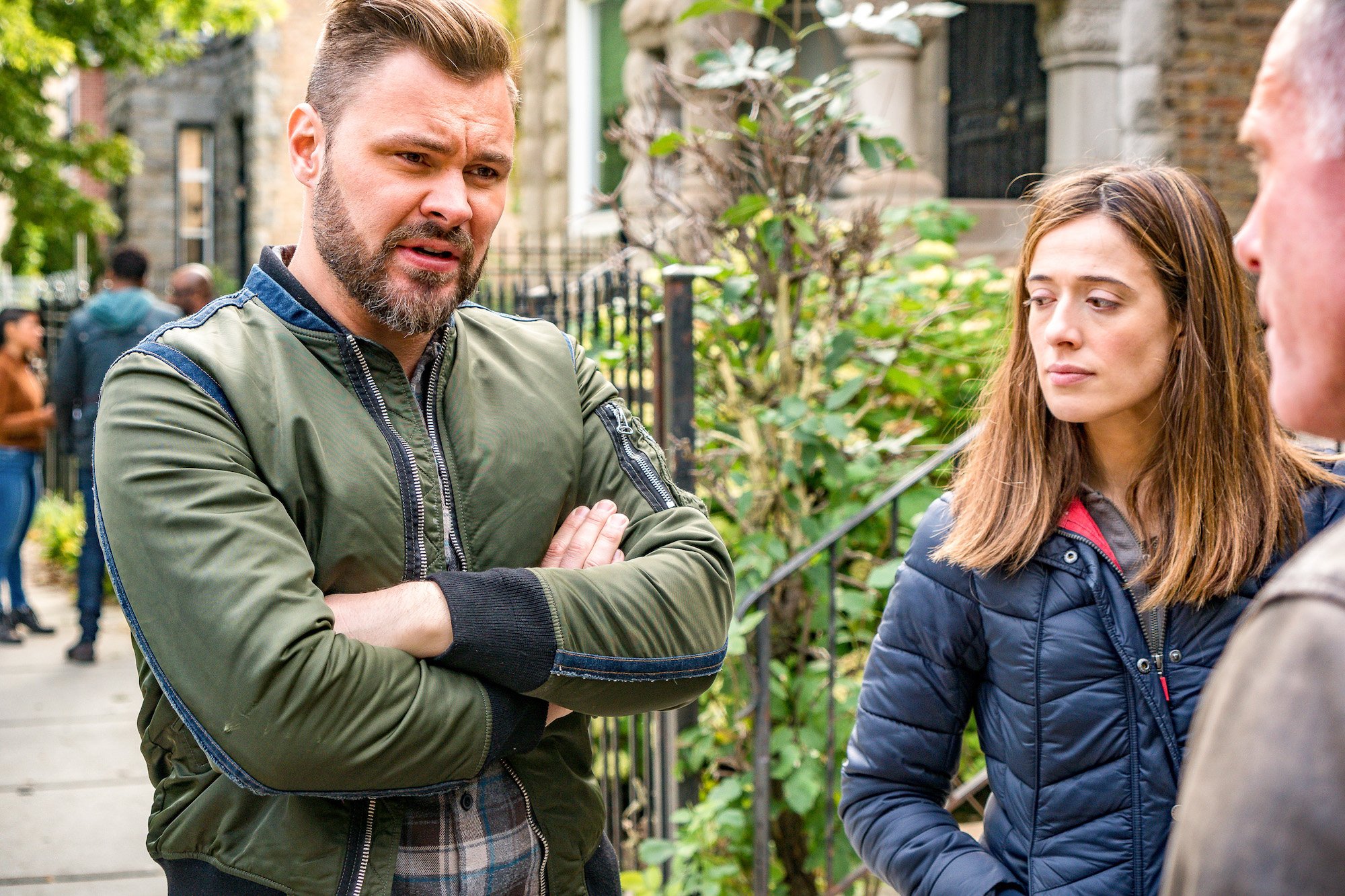 (L-R) Patrick John Flueger as Officer Adam Ruzek, Marina Squerciati as Officer Kim Burgess having a conversation with someone off camera