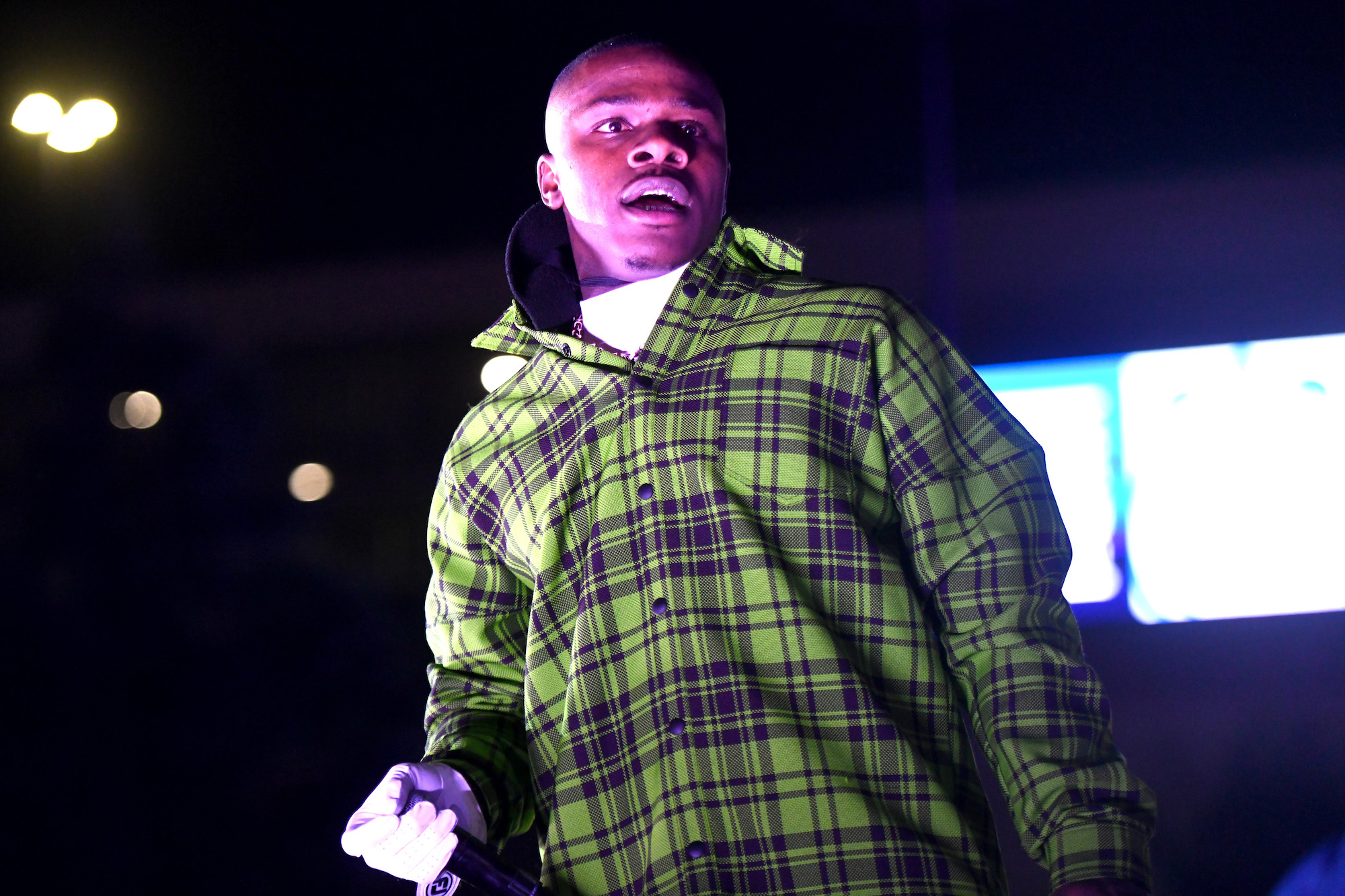 DaBaby on stage, looking down