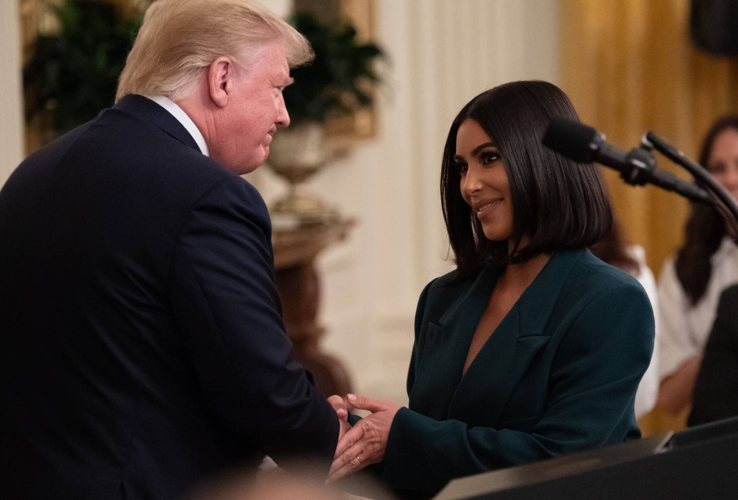 Kim Kardashian shakes hands with US President Donald Trump during a second chance hiring and criminal justice reform event in the East Room of the White House in Washington, DC, June 13, 2019.