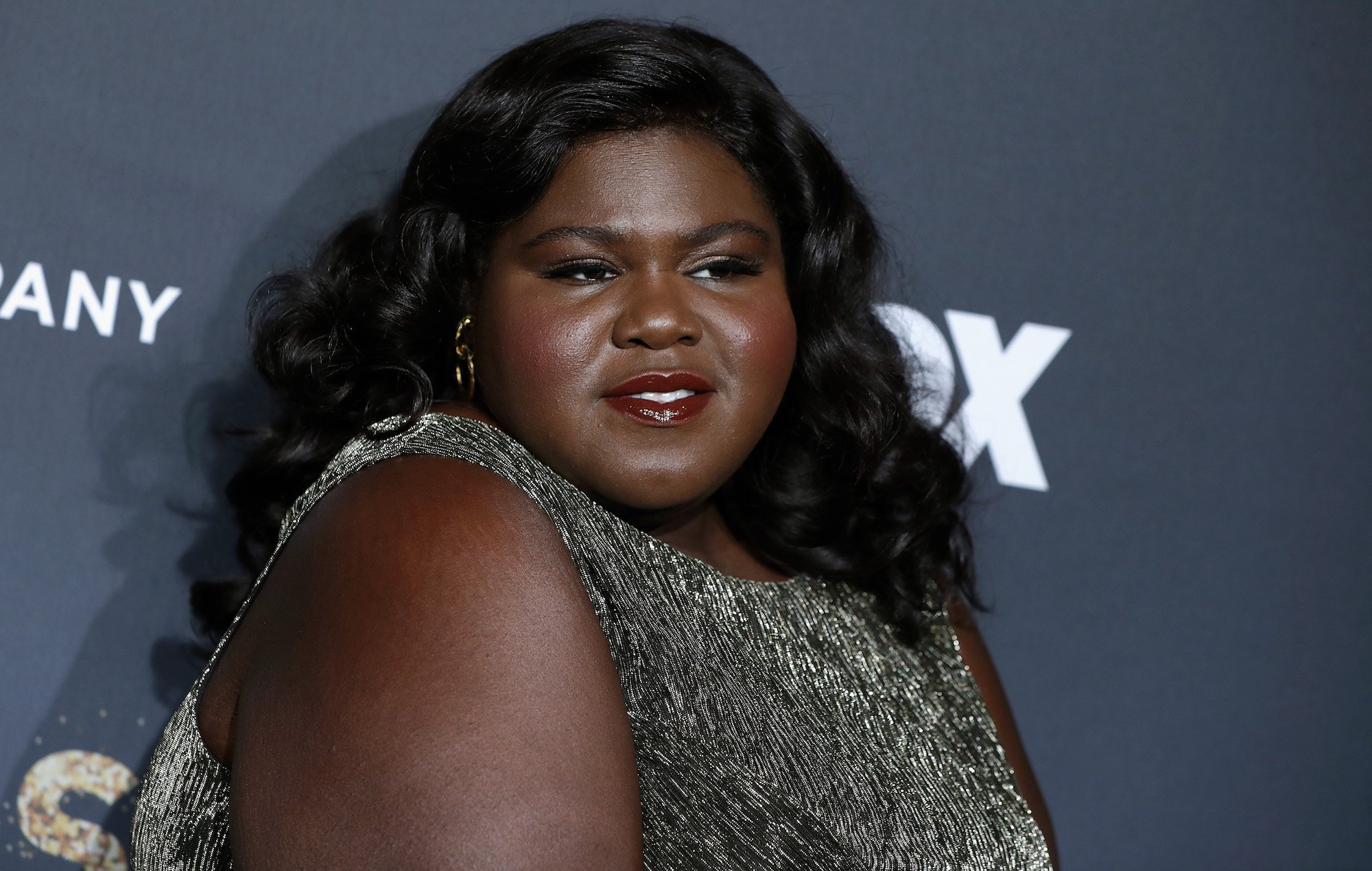 Gabourey Sidibe smiling slightly, turned to the side