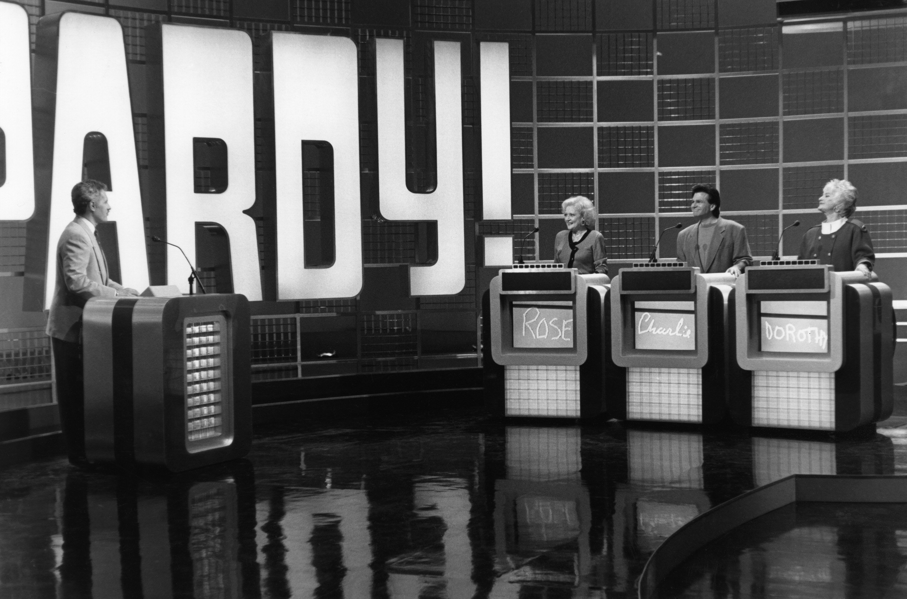 Betty White, far left contestant podium, as Rose Nylund on 'Jeopardy!' in an episode of 'The Golden Girls'