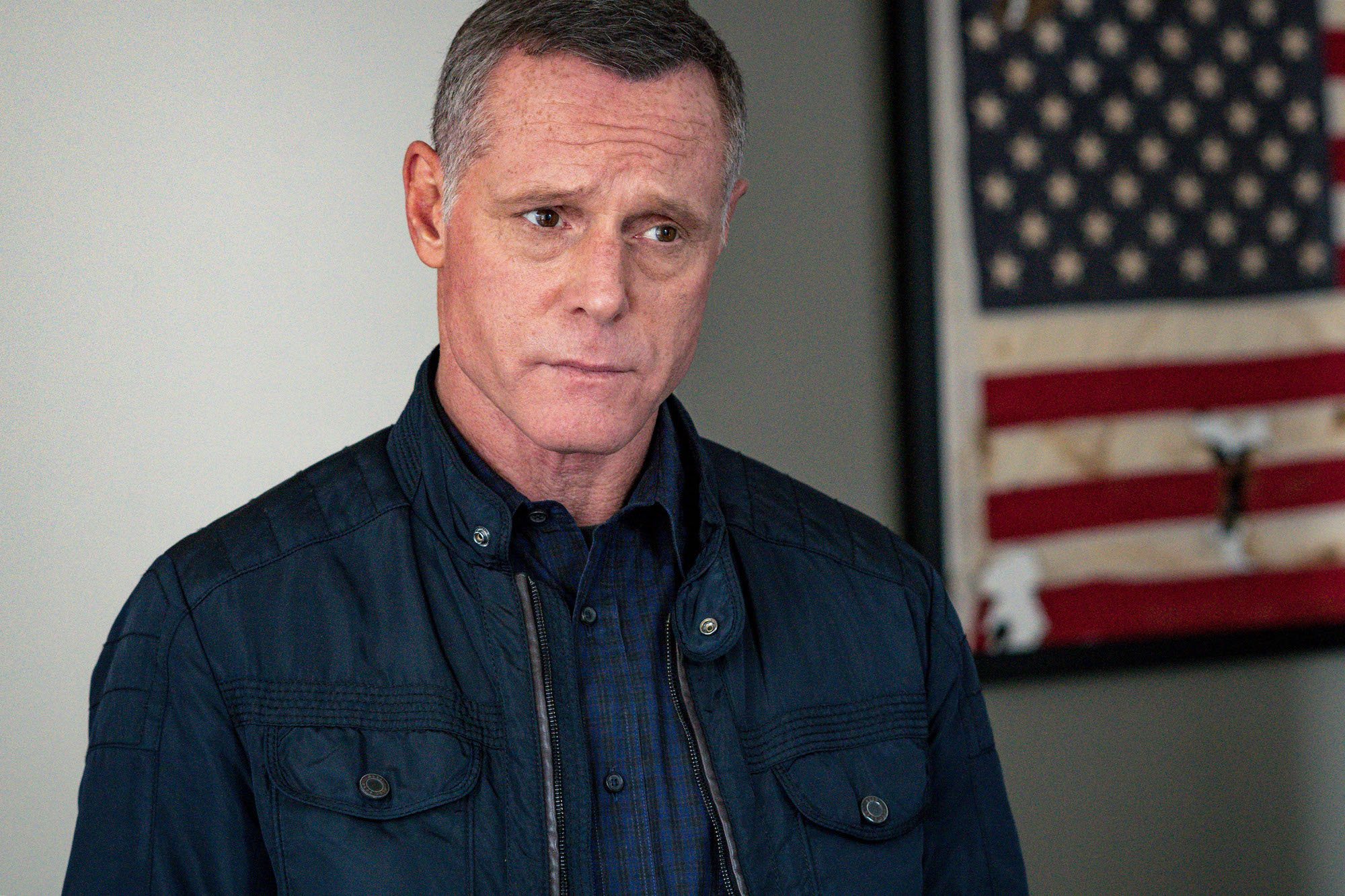 Jason Beghe as Hank Voight looking off camera, not smiling