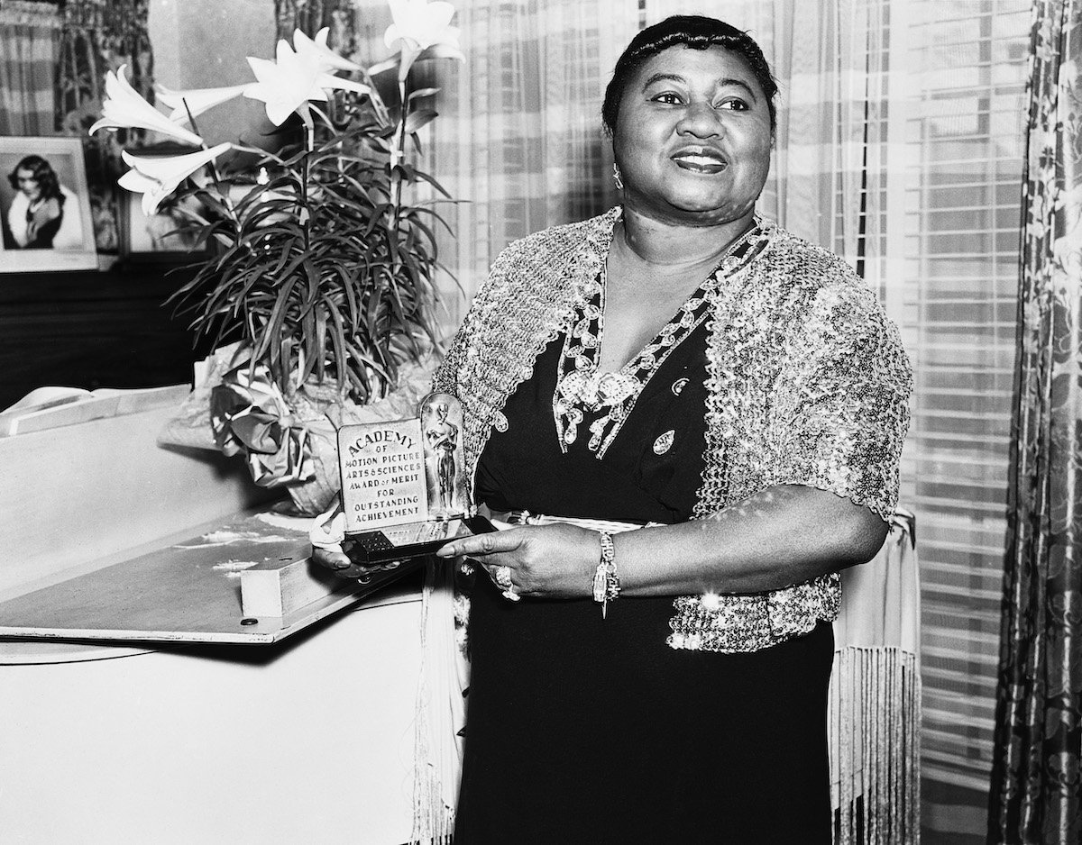 American actress Hattie McDaniel with her Academy Award of Merit for Outstanding Achievement, circa 1945. McDaniel won an Oscar for Best Supporting Actress for her role of Mammy in Gone With The Wind, making her the first African-American to win an Academy Award