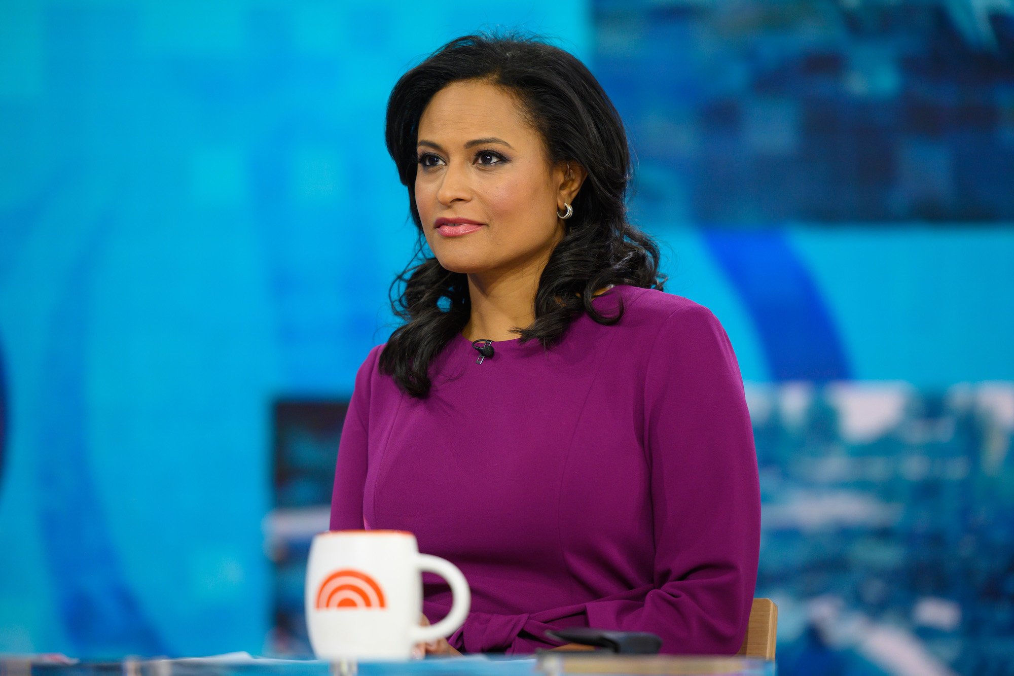 Kristen Welker slightly smiling, looking off to the left, in front of a blue background