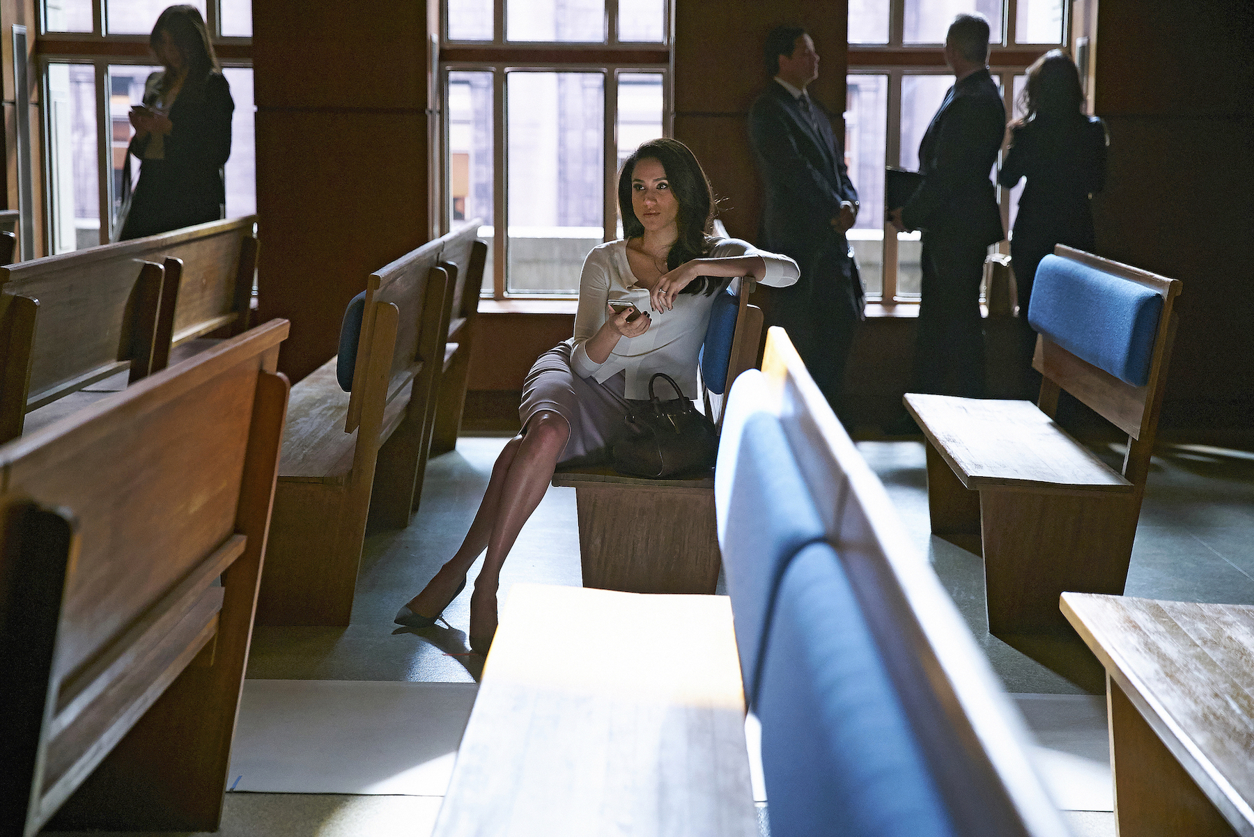 Meghan Markle as Rachel Zane sitting on a bench