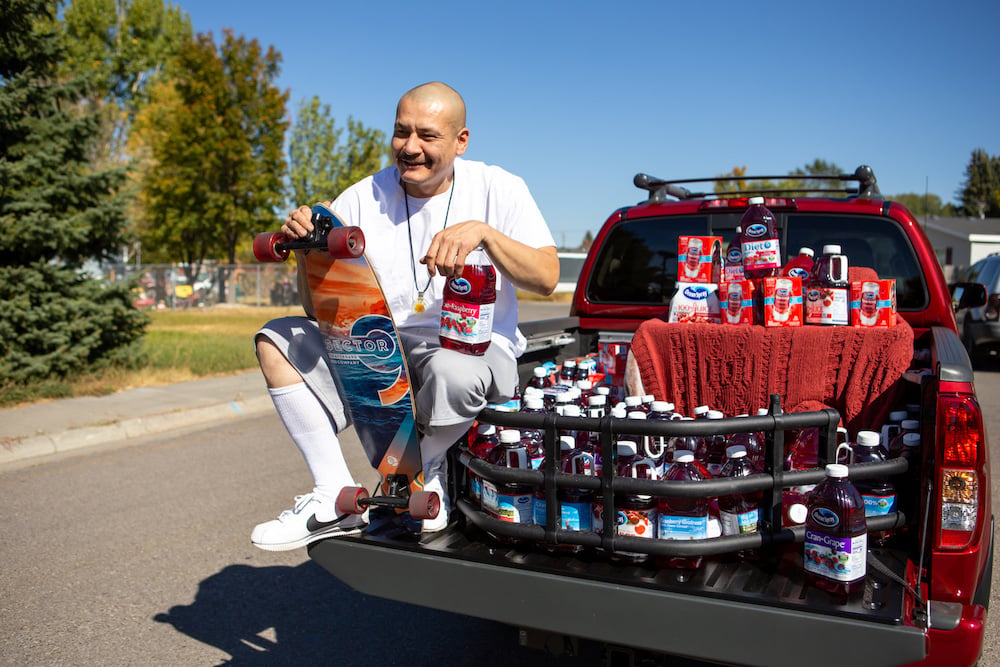 TikTok star Nathan Apodaca, aka 420doggface208 smiling, sitting on the back of a pickup truck