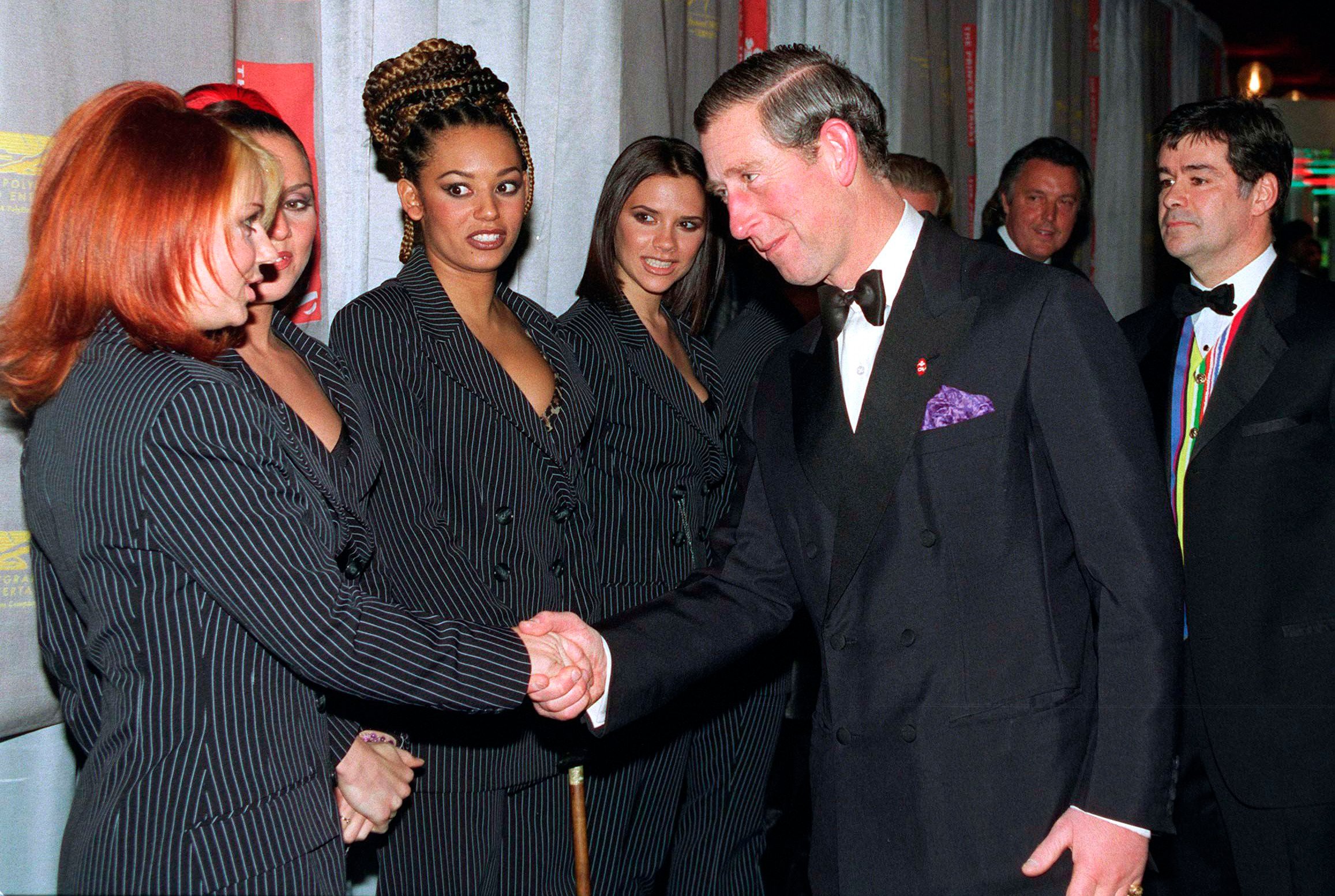 Prince Charles shaking hands with Geri Halliwell and other Spice Girls