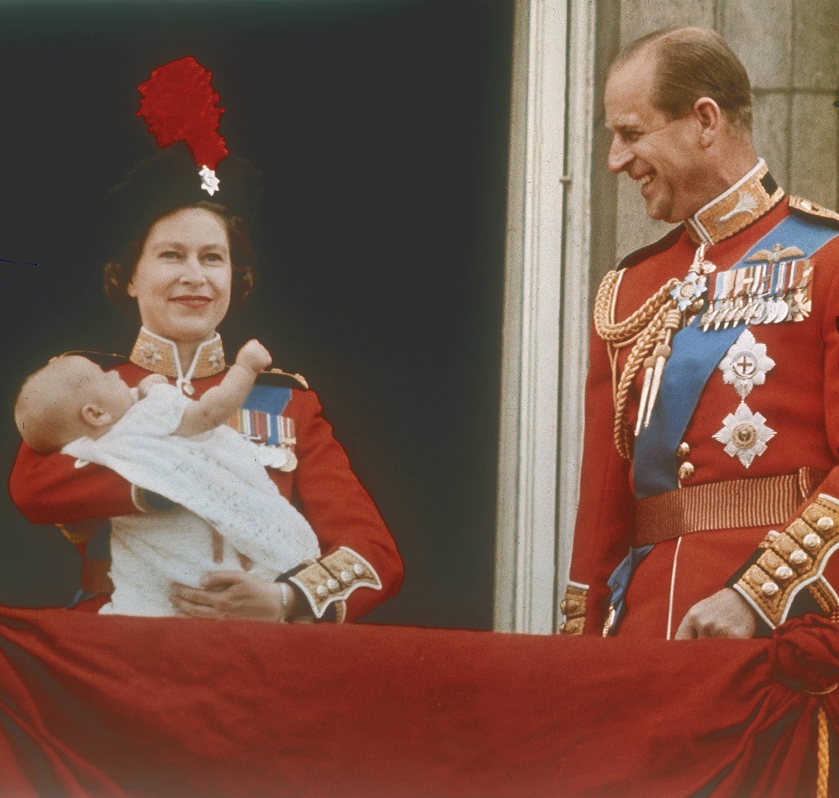  Queen Elizabeth II holding an infant Prince Edward on the royal balcony with Prince Philip