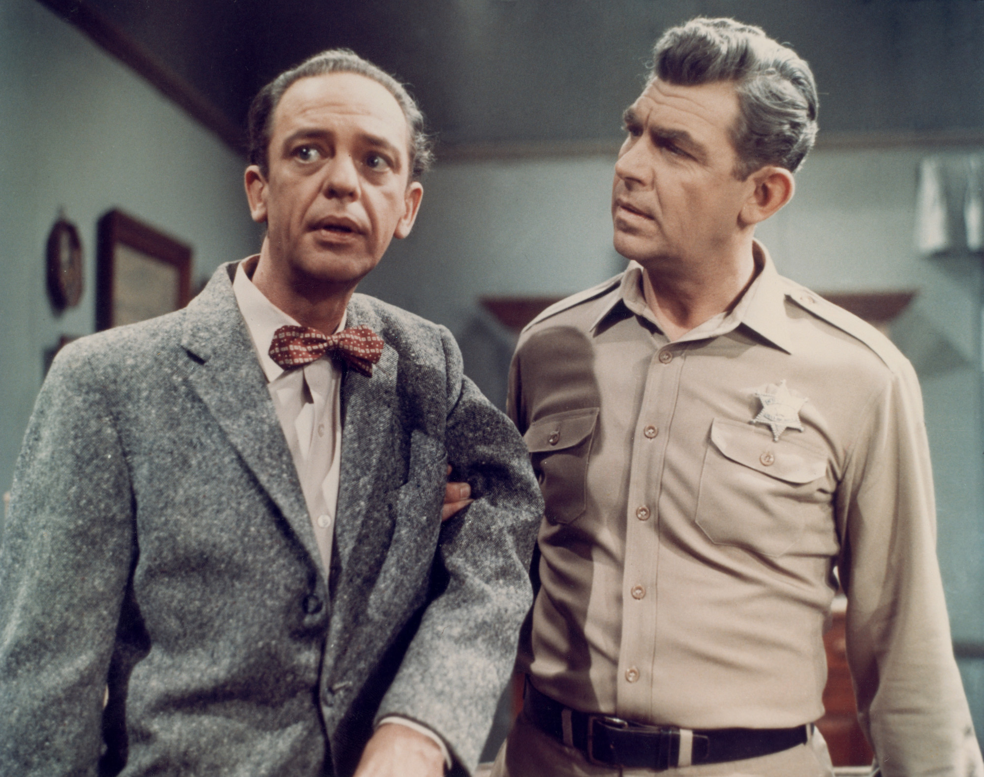 (L-R) Don Knotts as Deputy Barney Fife looking off to the left and Andy Griffith as Sheriff Andy Taylor looking at Knotts