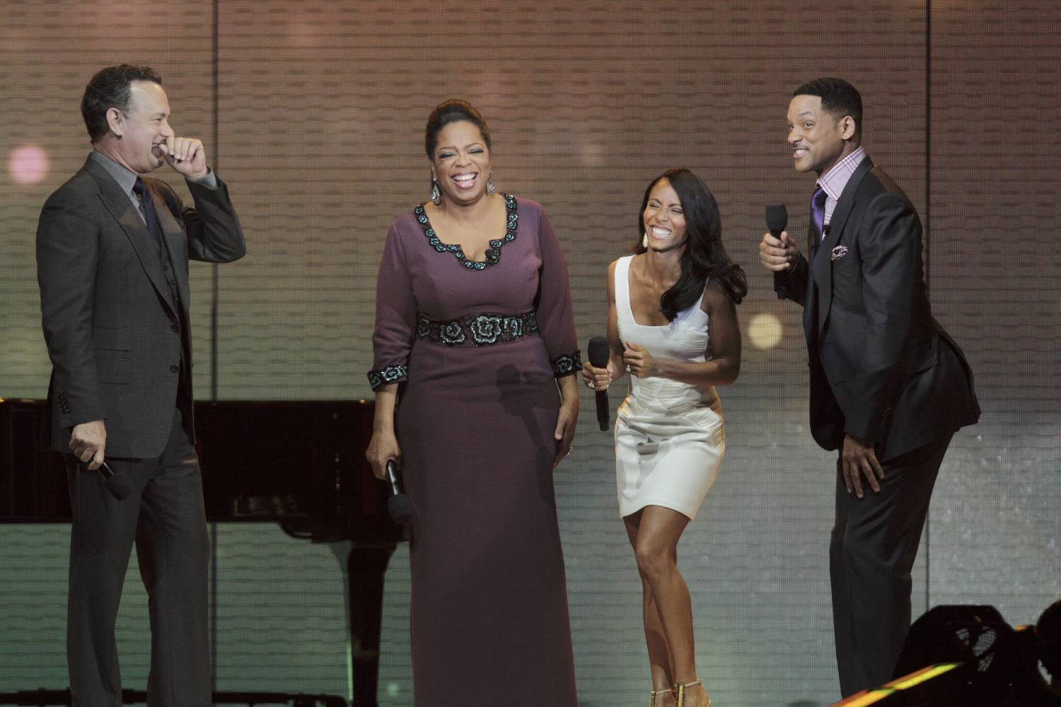 Will Smith (R), Oprah, Jada Pinkett Smith (2nd R), and actor Tom Hanks share a laugh during the taping of the show's Surprise Spectacular in Chicago May 17, 2011.