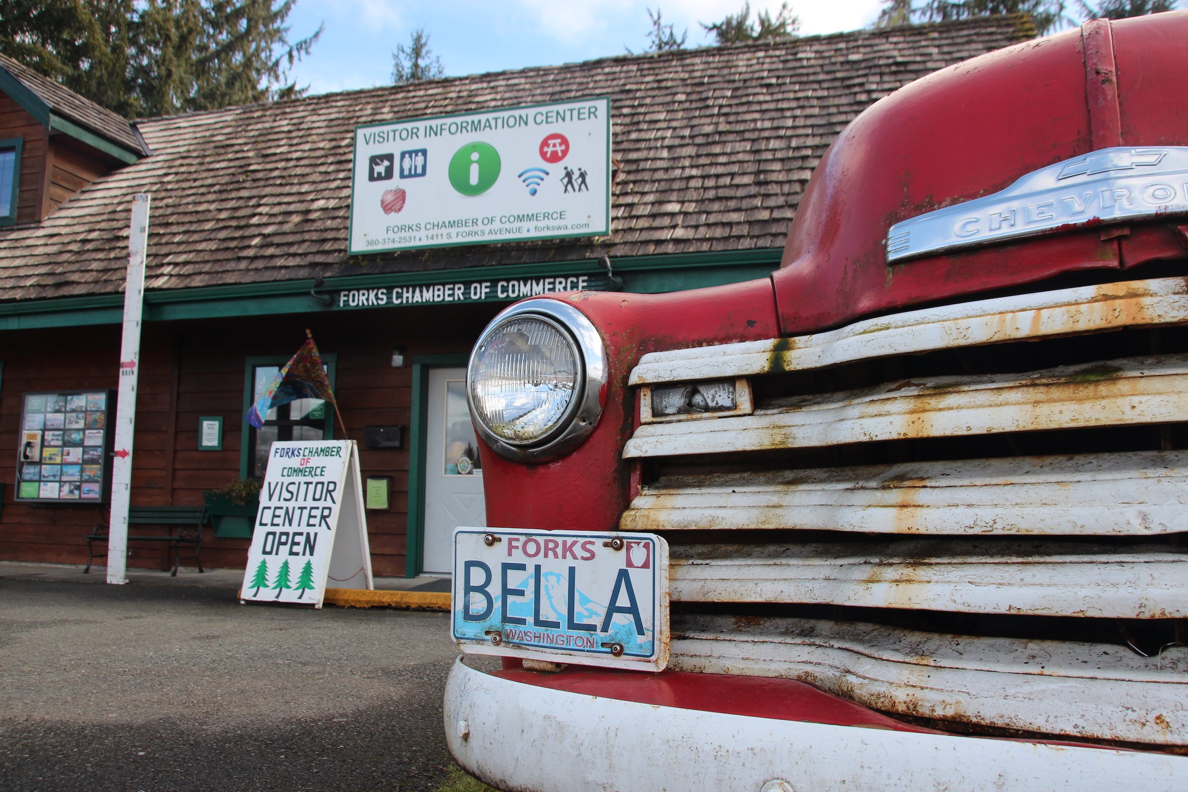 An old Chevrolet is parked in front of the visitor centre in the small town of Forks